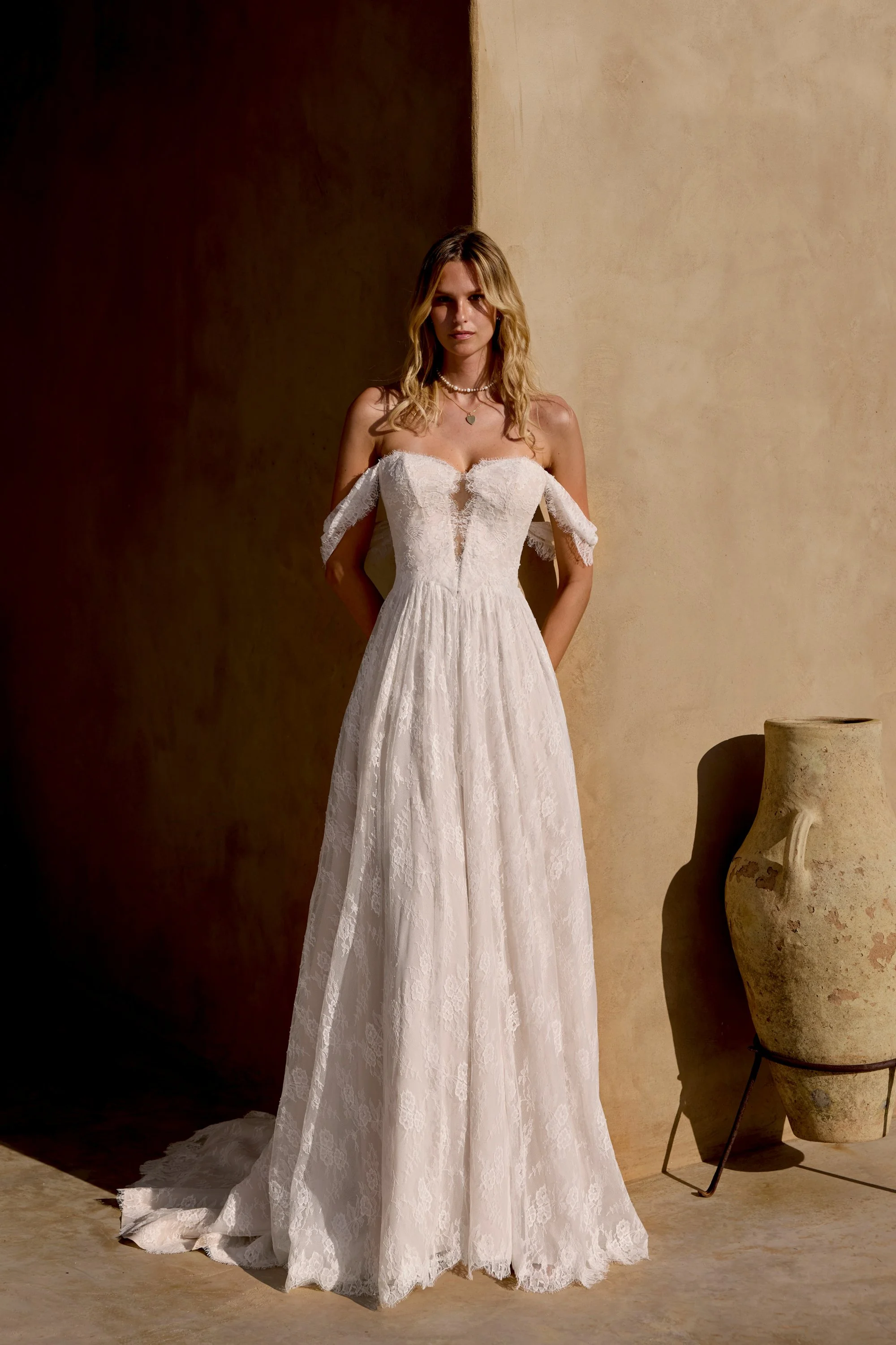 A-line lace Lillian West wedding dress with drop shoulder sleeves and scalloped lace edge.