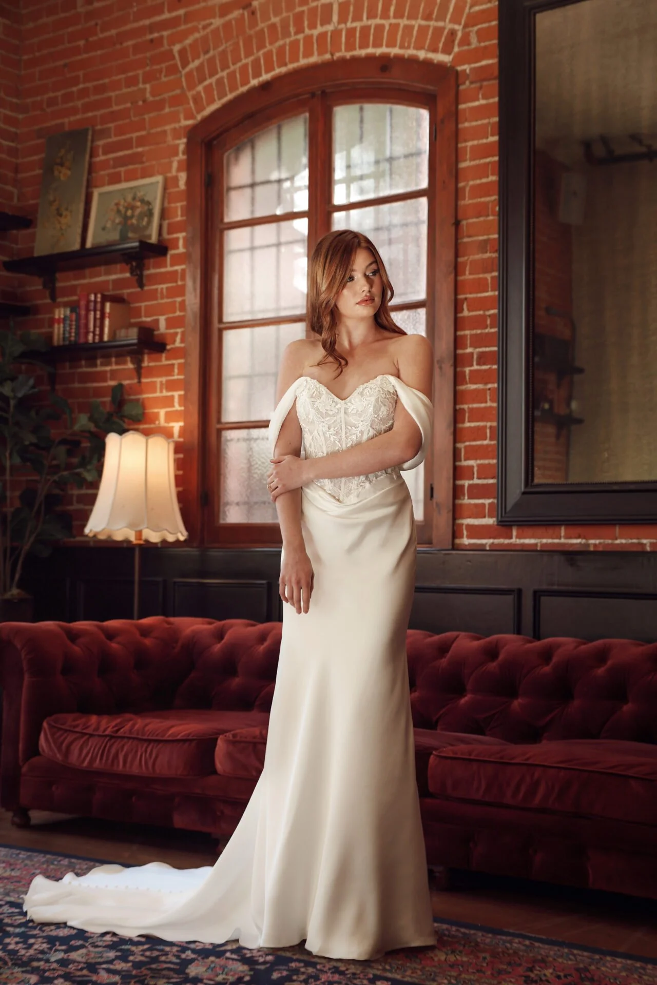 Lace and charmeuse fitted column Essense of Australia wedding dress with rouged waistline and charmeuse drop shoulder sleeves on a sweetheart neckline.