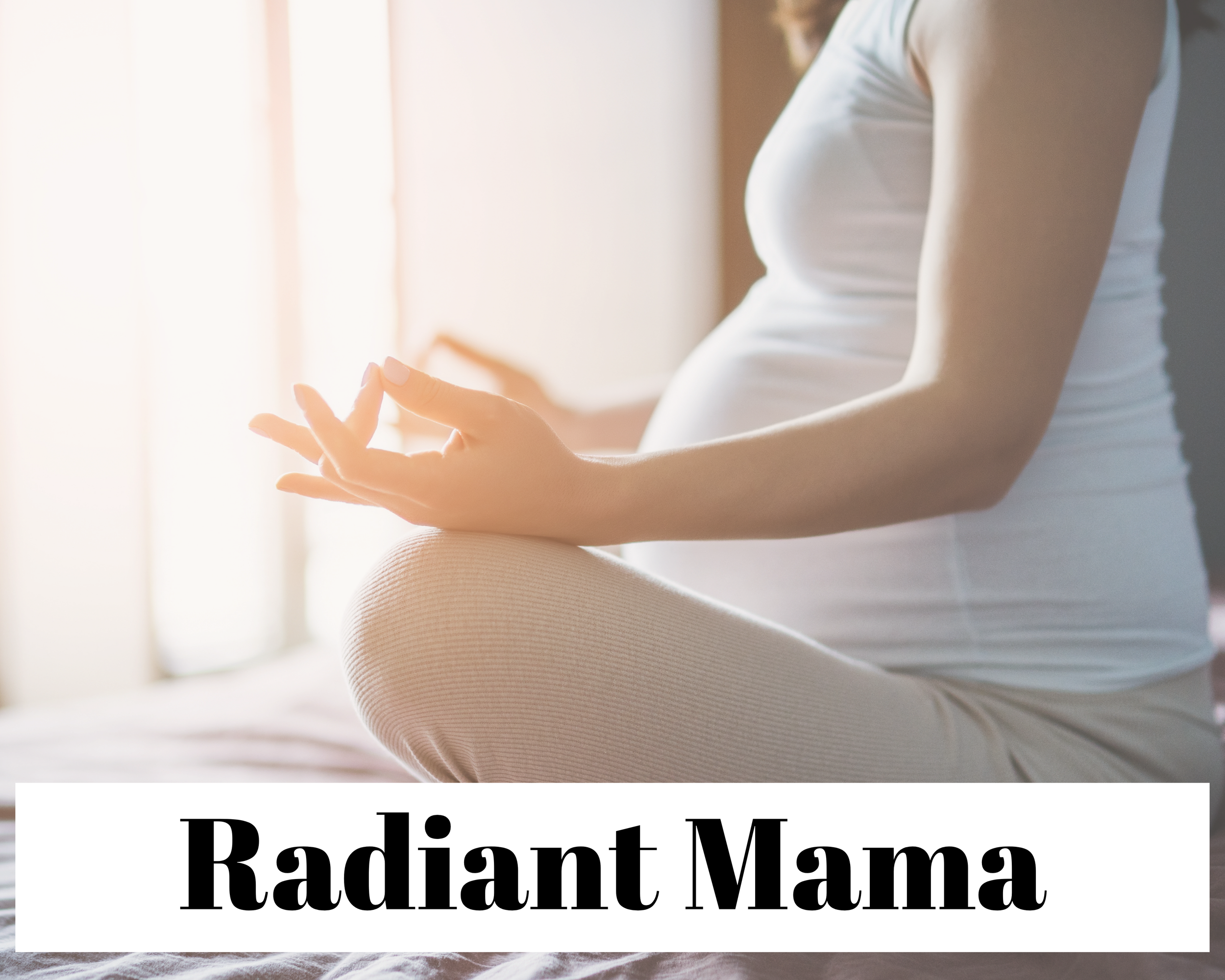 A pregnant woman sitting cross-legged on a yoga mat, practicing meditation with her hands in a mudra gesture, in a softly lit room.