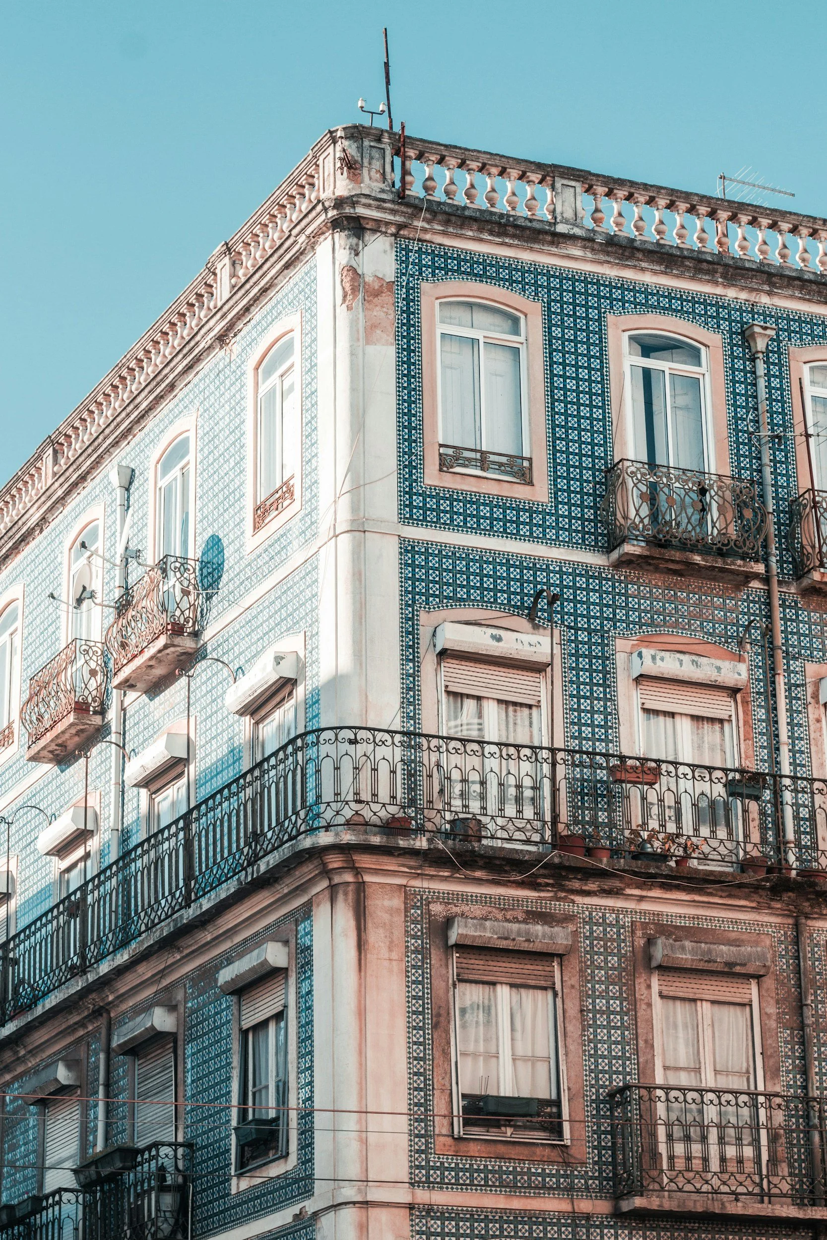 Corner of a Lisbon building covered in traditional blue and white azulejo tiles