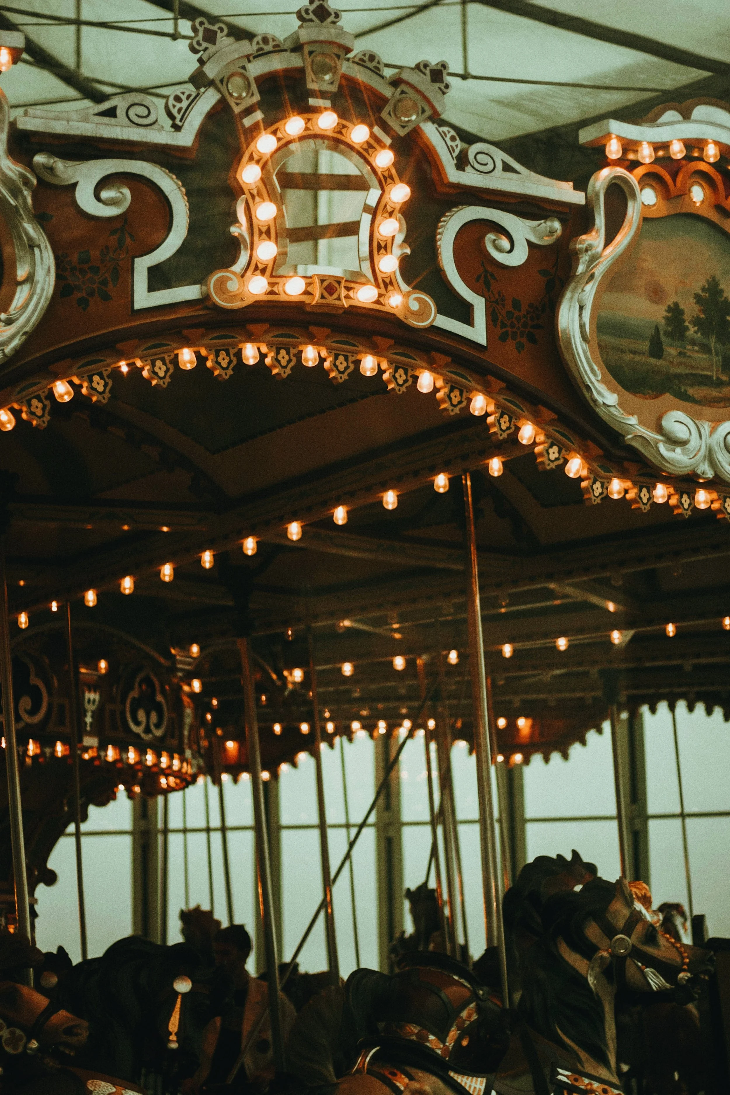 Jane's Carousel glass pavilion on the Brooklyn Bridge Park waterfront, with the Manhattan skyline behind