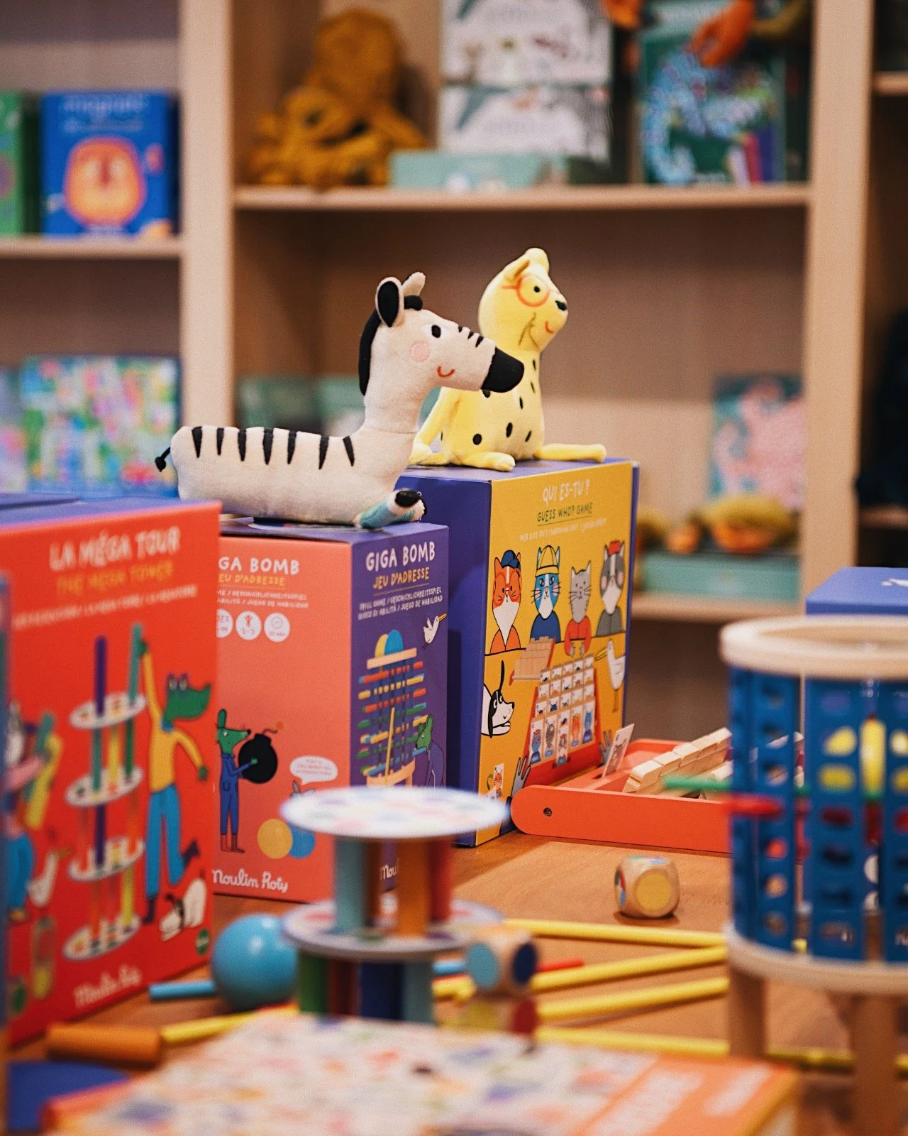 Moulin Roty toys and board games displayed in a Paris shop, including La Méga Tour and Giga Bomb