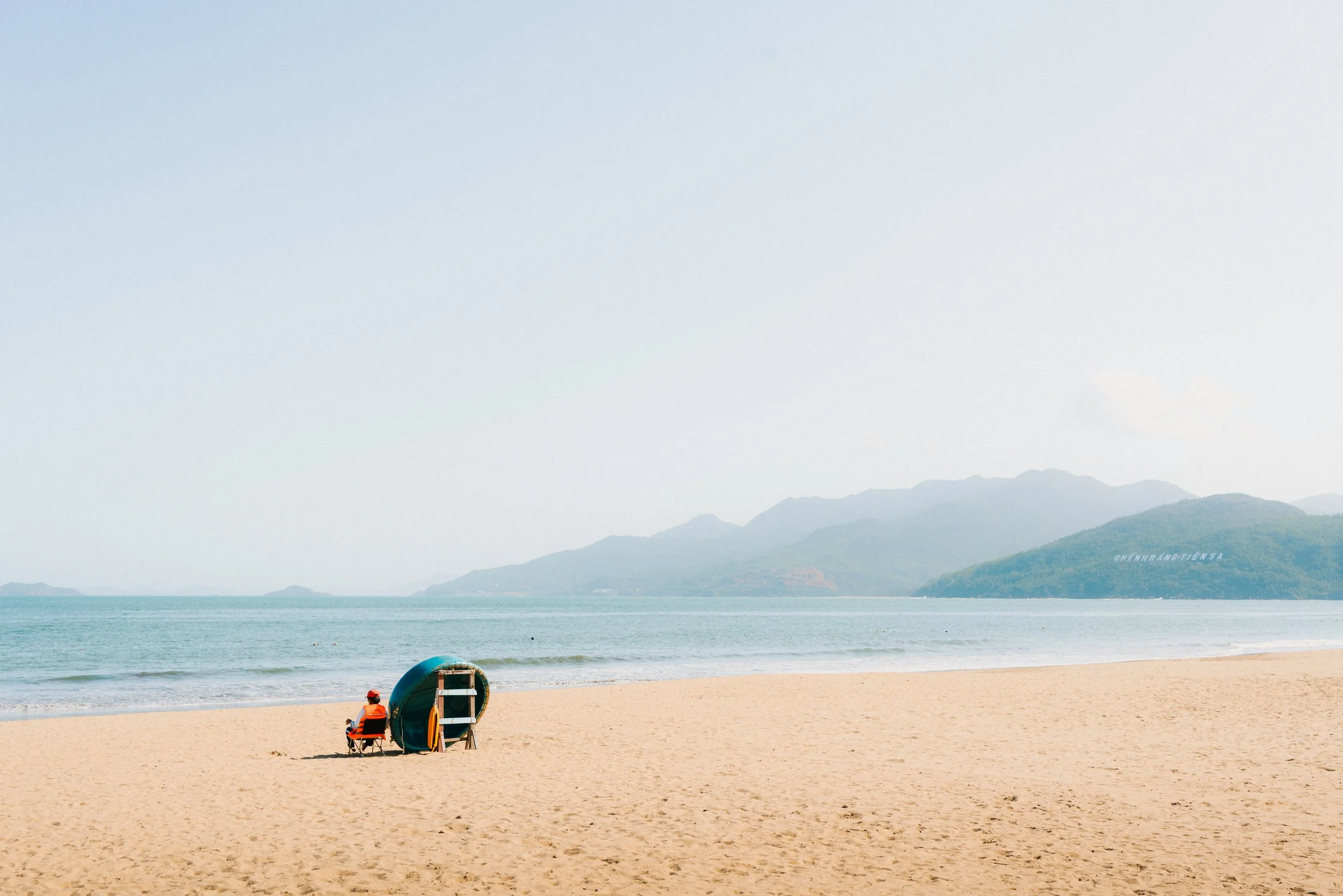 Man with bamboo coracle boat on a beach in Vietnam