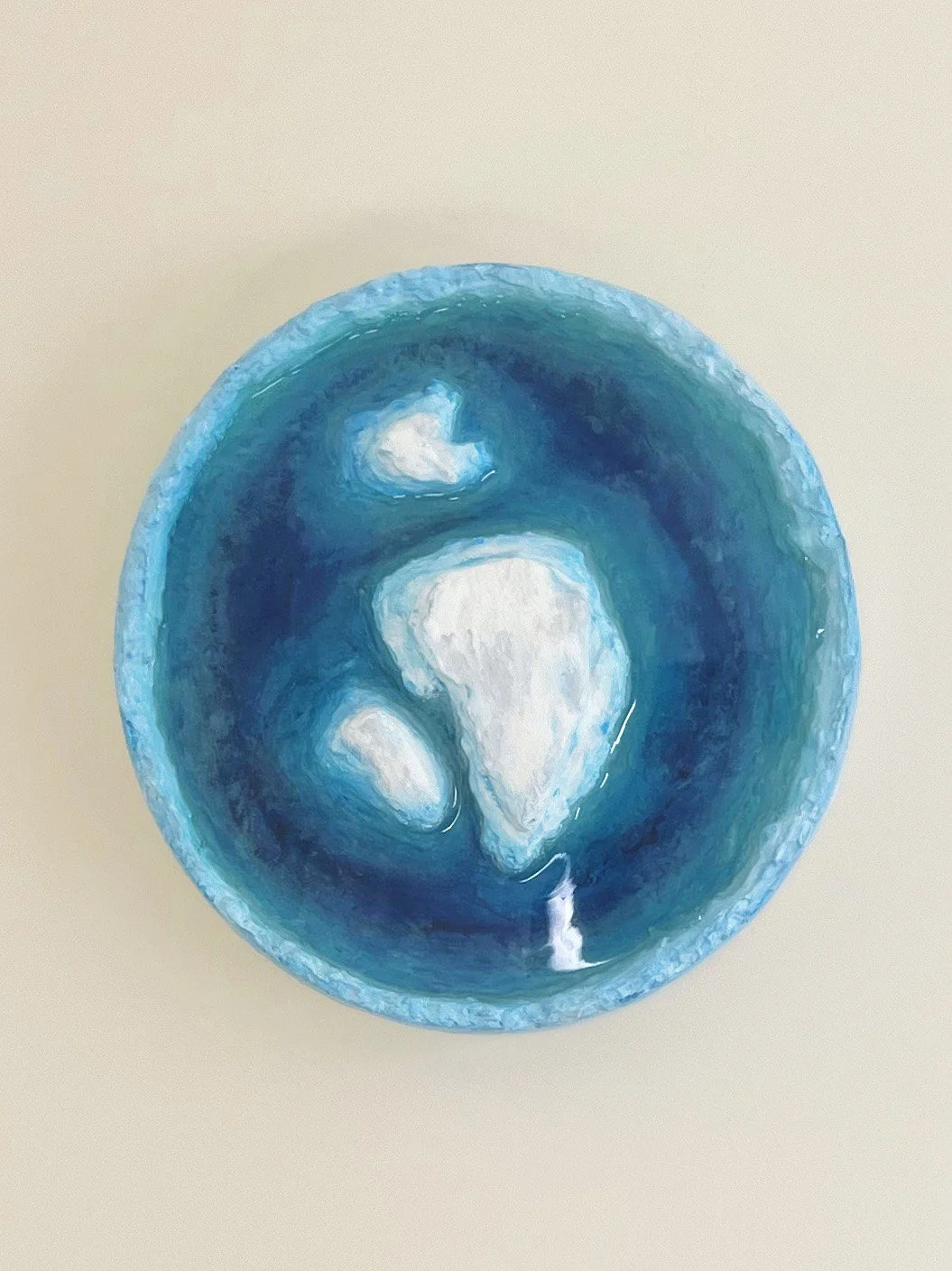 View of a blue ocean with an abstract painting of iceberg, white and shades of blue.