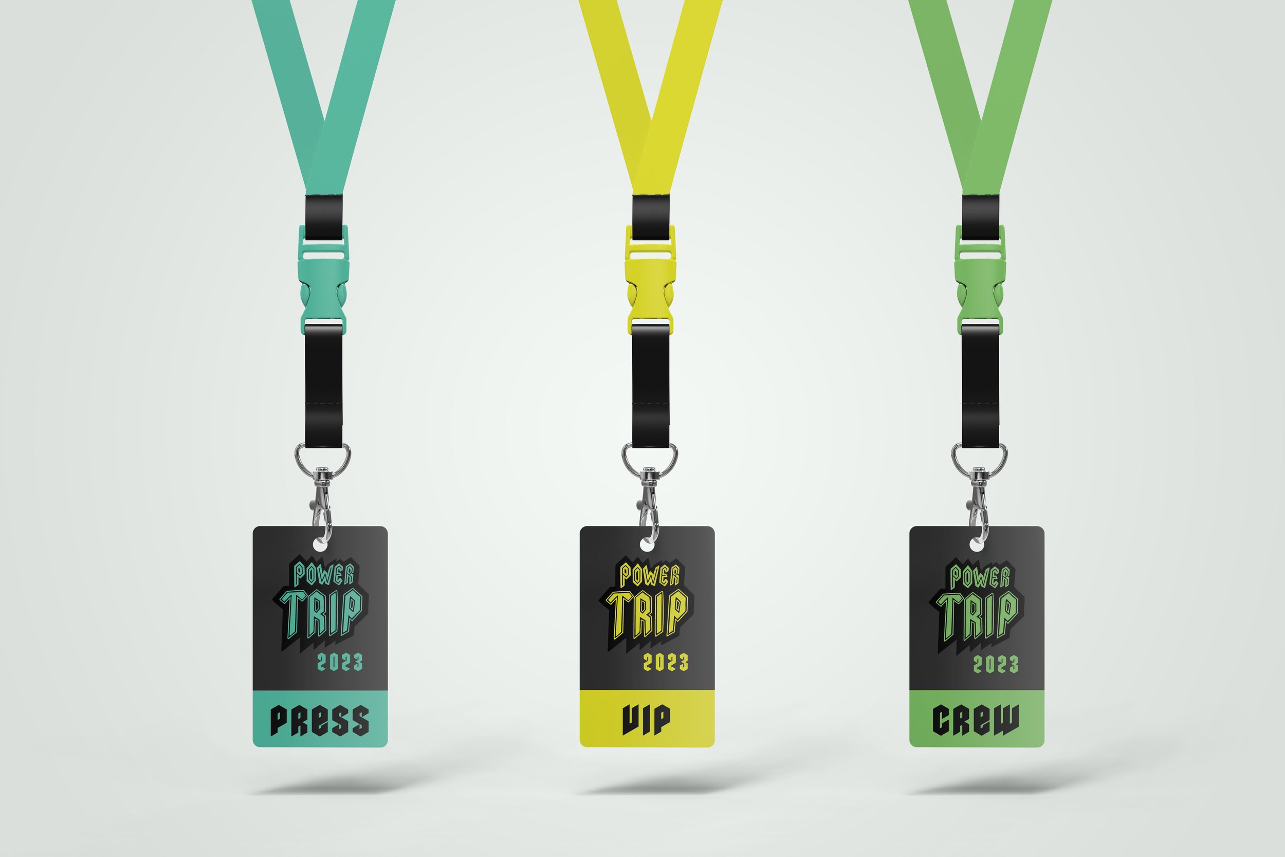 Three PowerTrip branded festival passes on lanyards. One is teal blue and says "Press", the second is yellow and says "VIP", and the third is lime green and says "Crew". They all feature a corresponding colored stacked PowerTrip logo and "2023".
