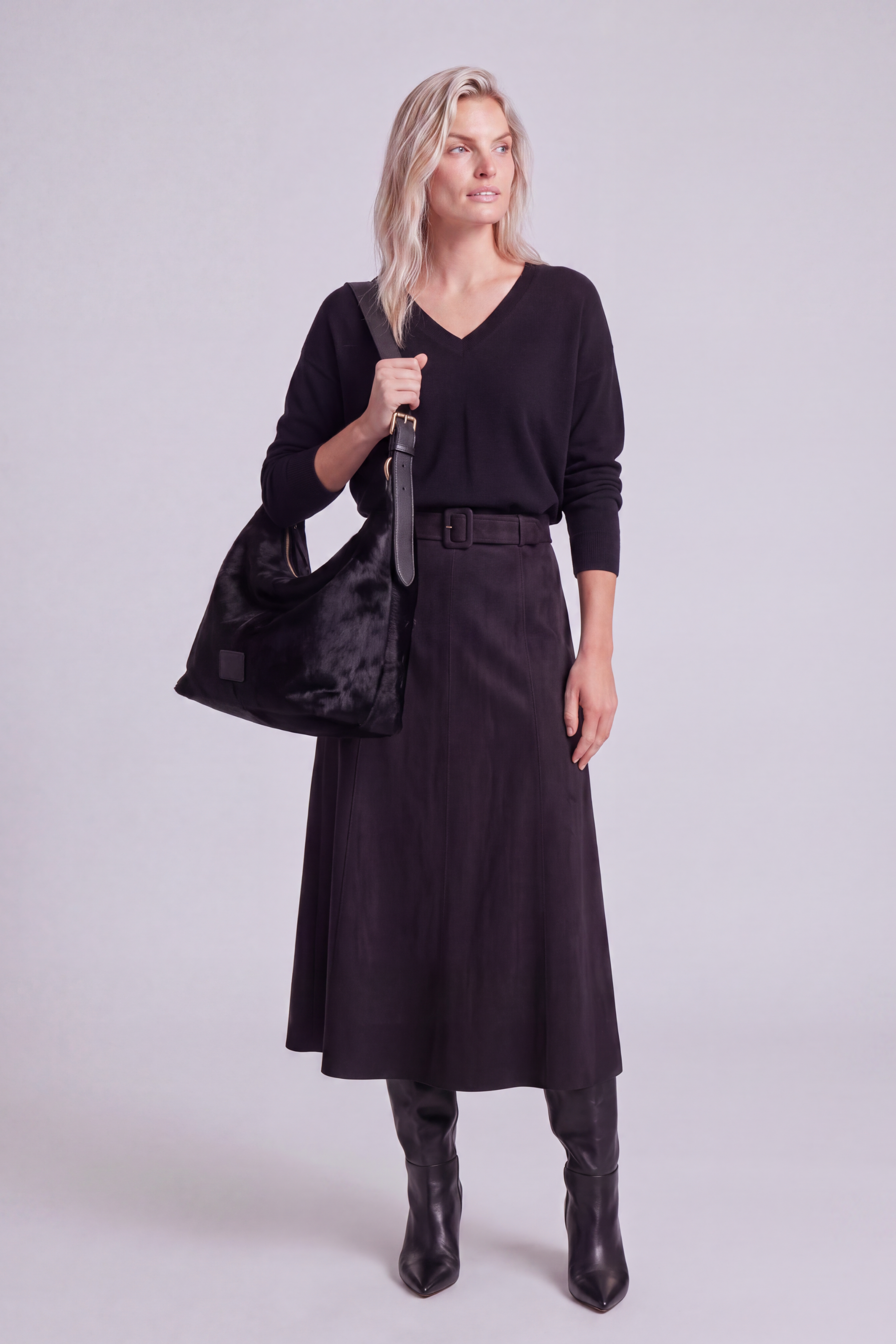 Model shown from the front wearing the black a-line faux suede skirt