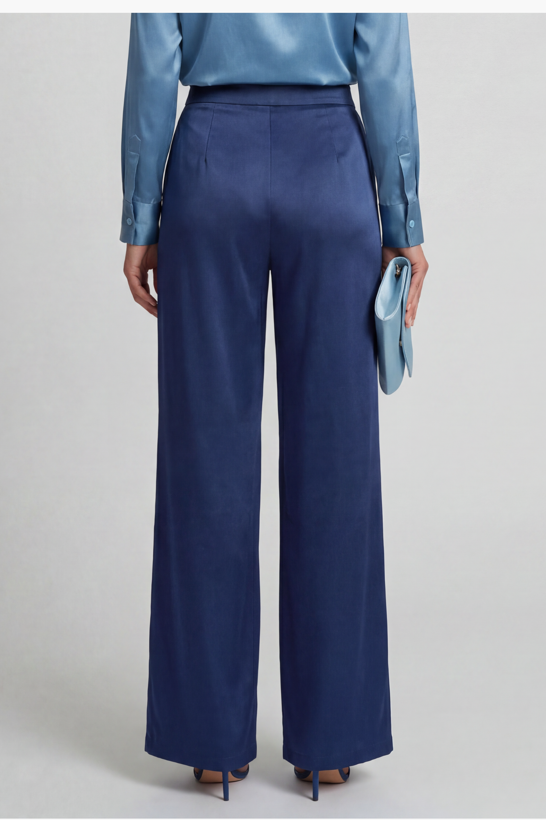 Back view of wide leg pant in navy silk worn by a model