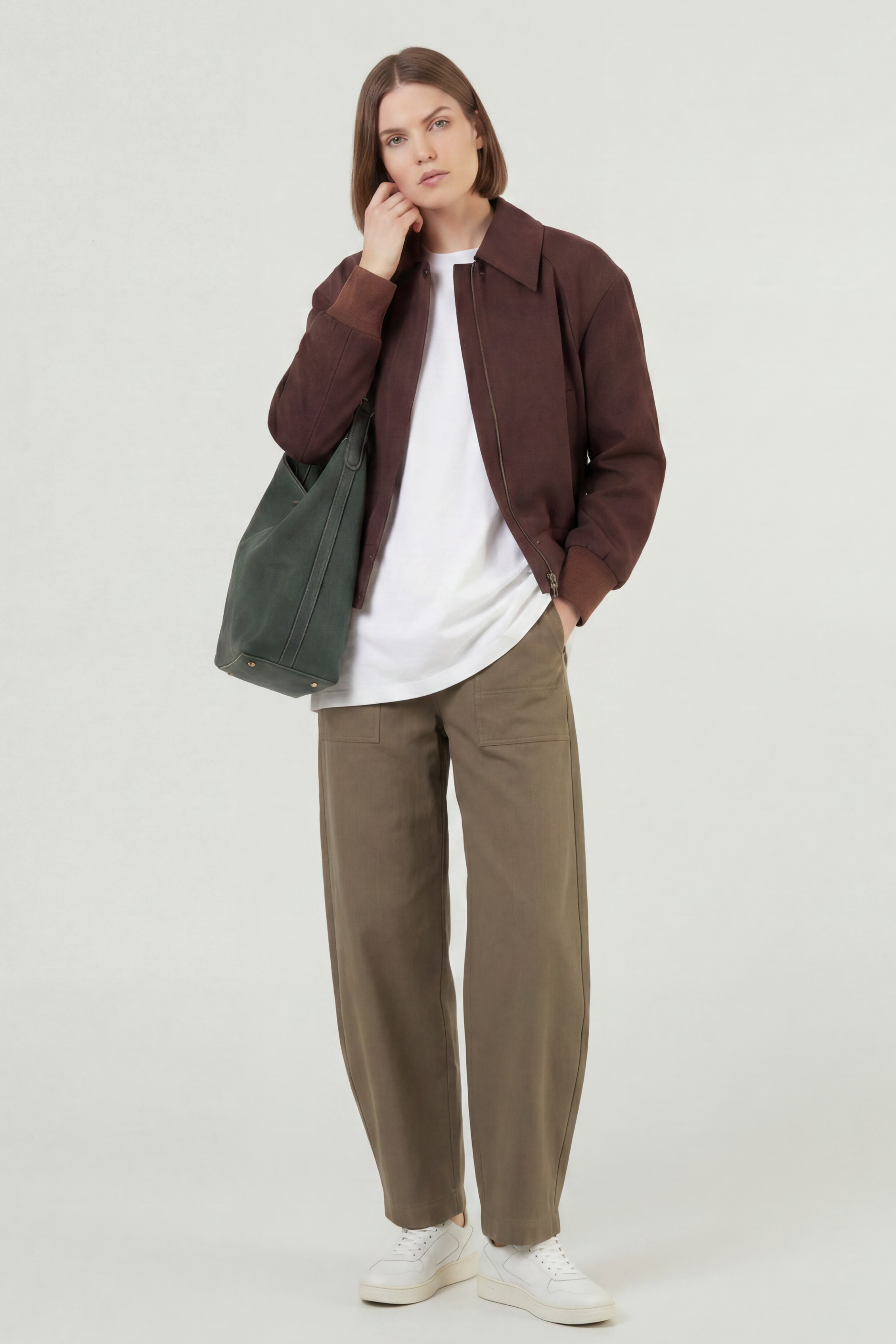 Brunette model wearing the chocolate brown faux suede bomber