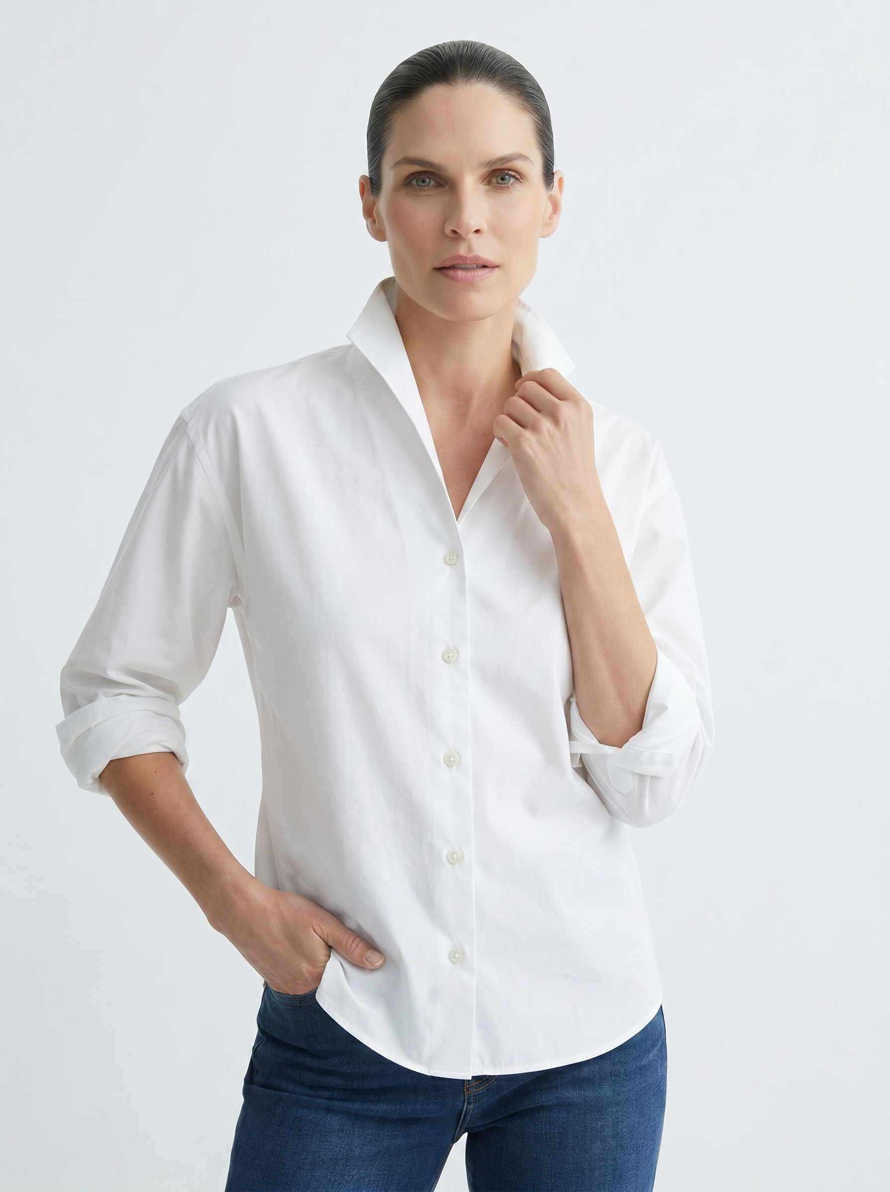 Model wearing The Lucie Button Up Shirt in white cotton showing off the one-piece collar
