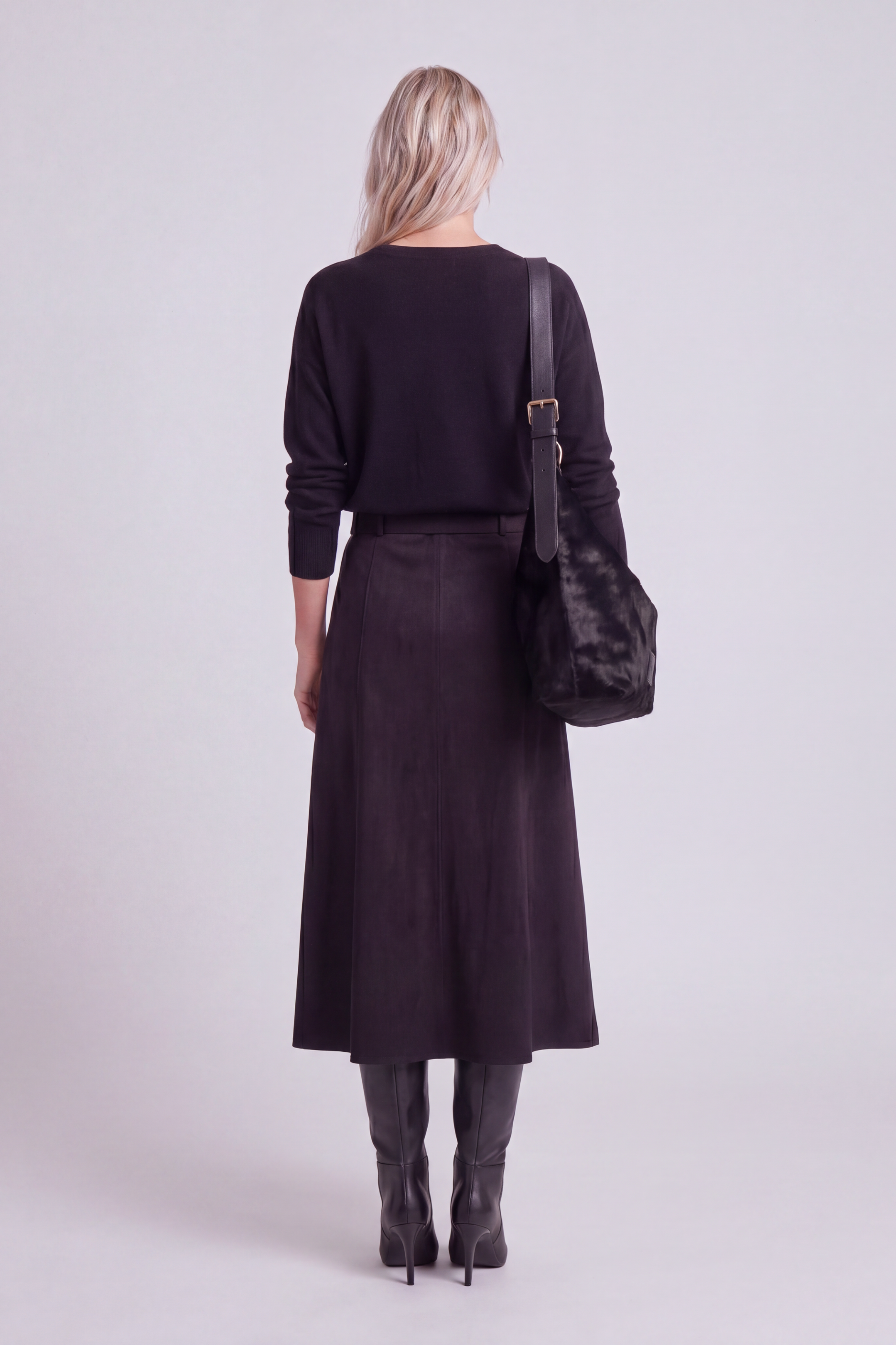 Model shown from the back wearing the black a-line faux suede skirt