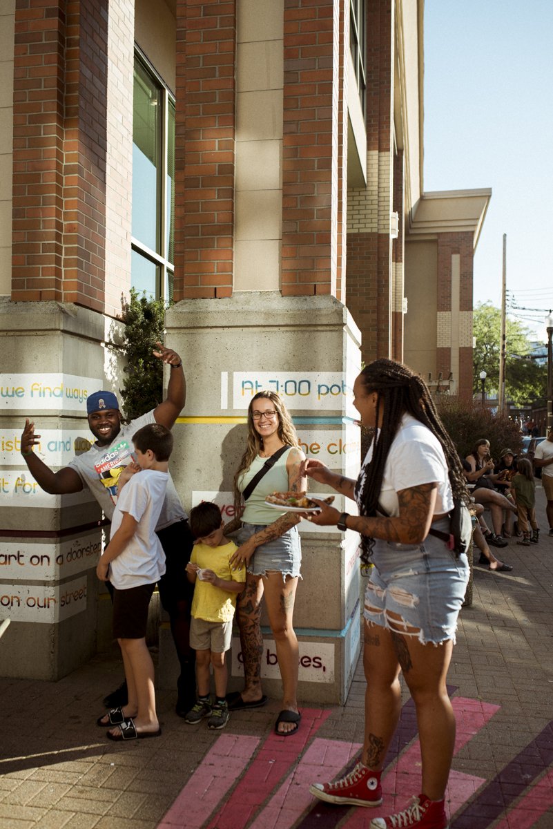 A family enjoying themselves at a street event. 