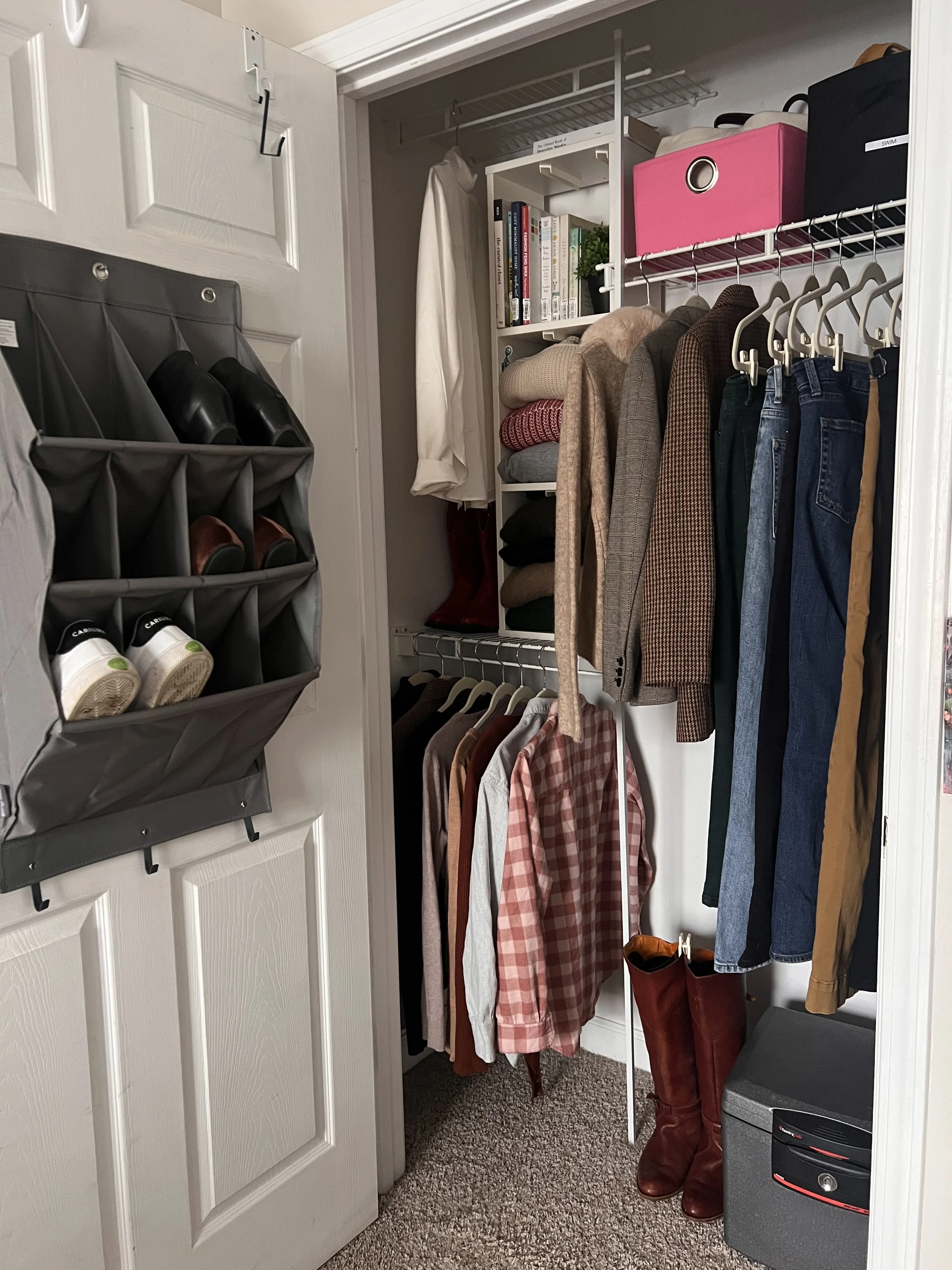 Image of a minimalist closet for winter/cool weather with main colors being red/rose, green, denim, gray, black, tan and ecru.