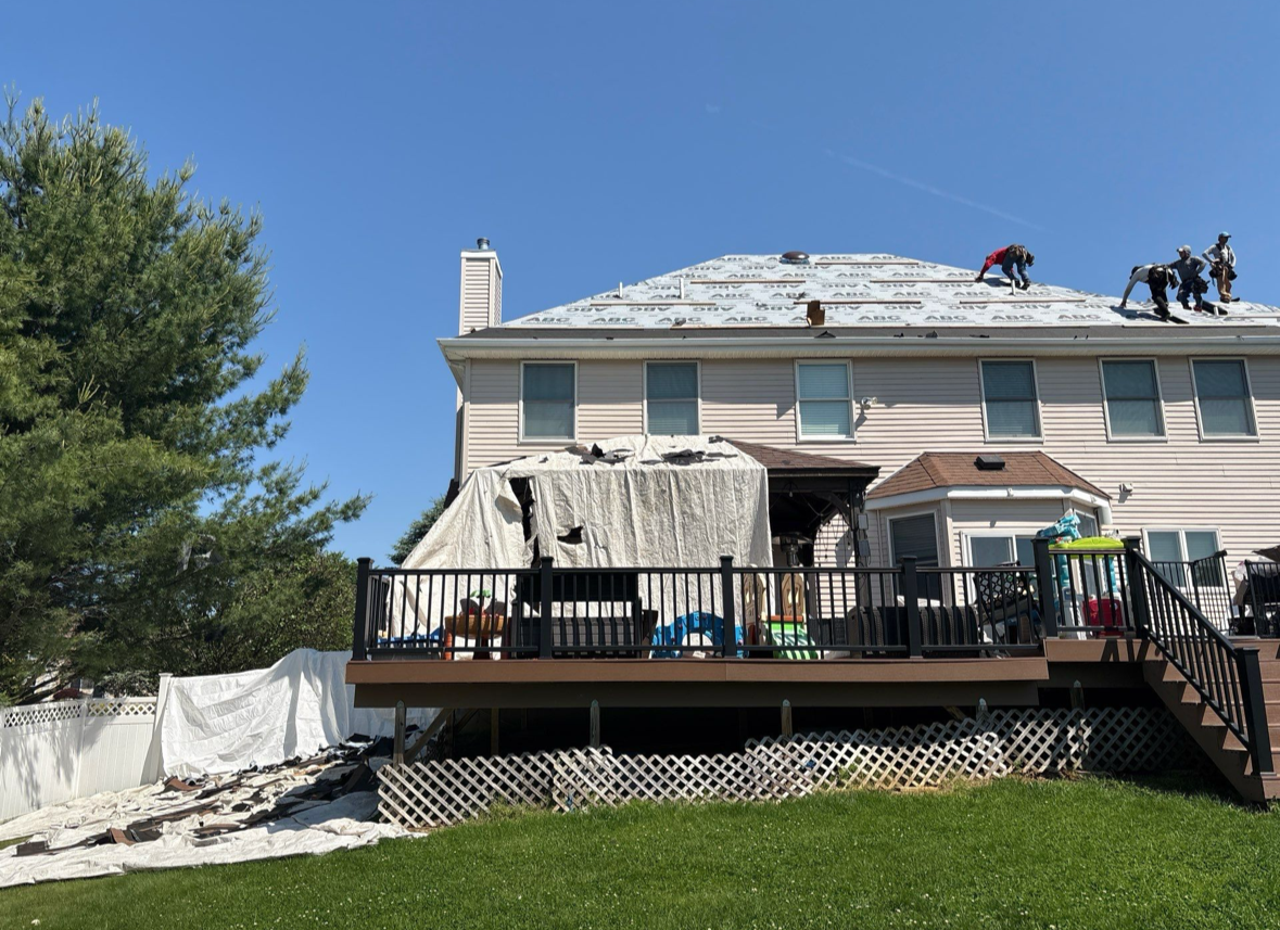 Installing synthetic underlayment.