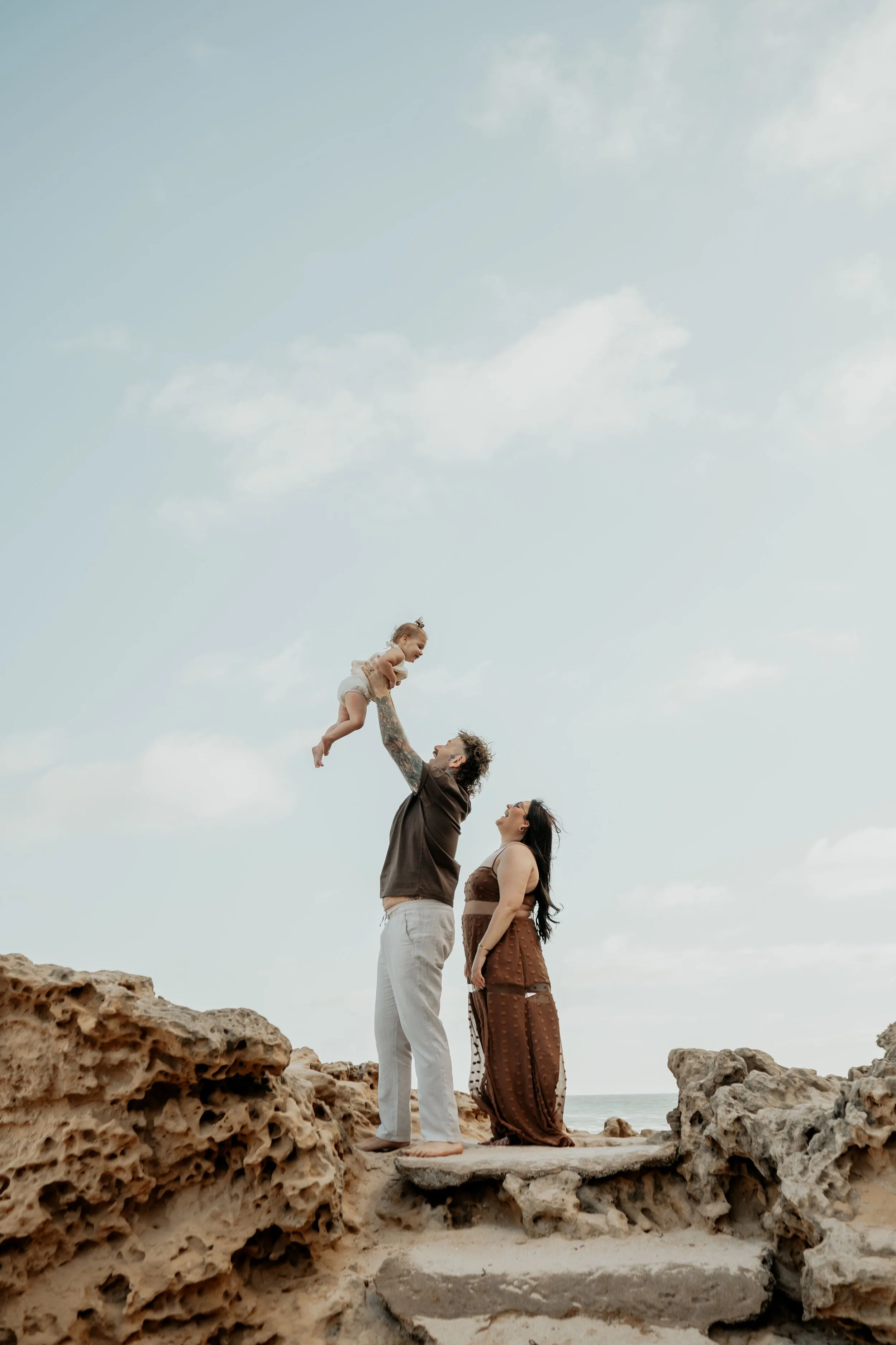 A mother and father play with their toddler