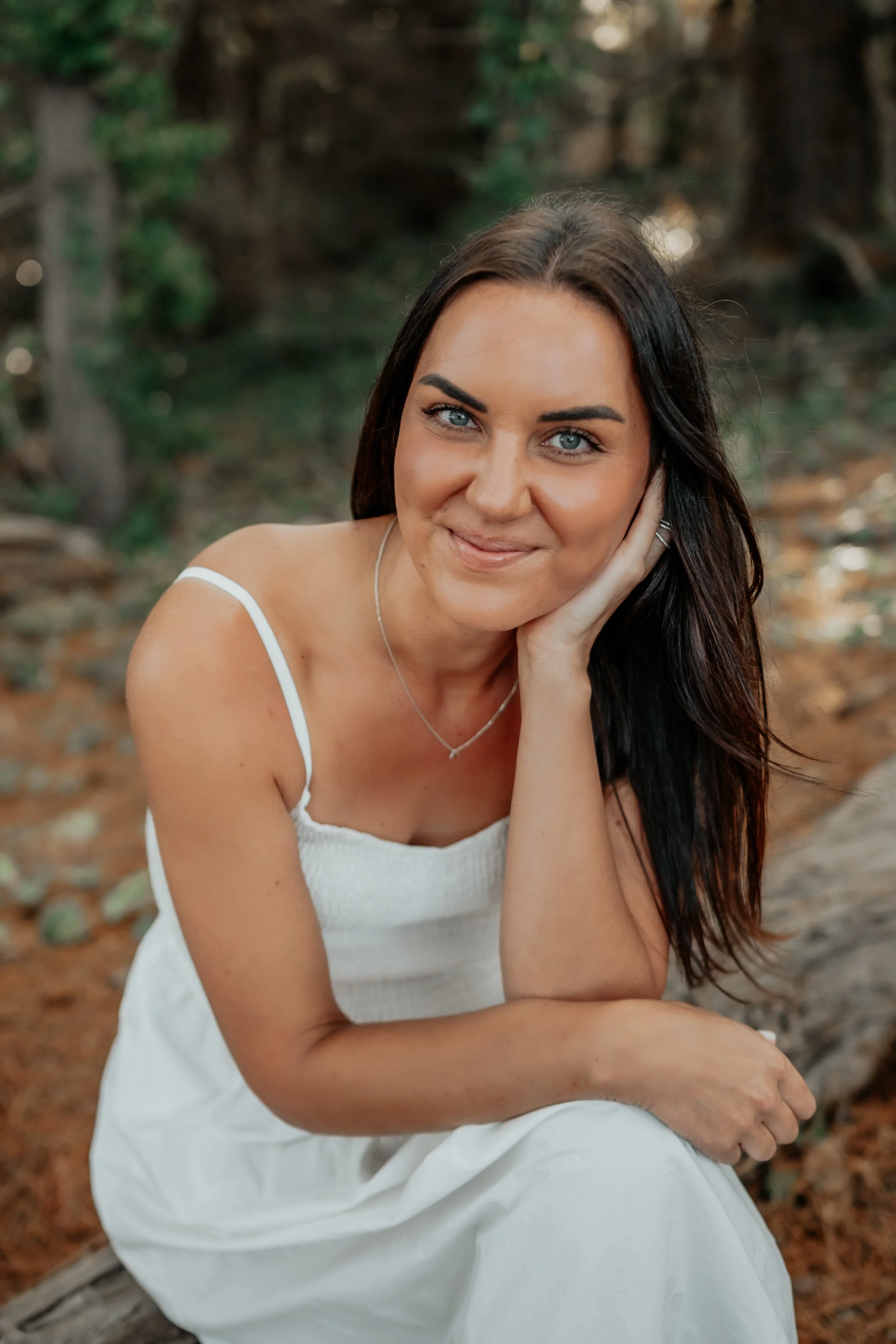 Bek Byrne of Captured by Bek Photography sitting and smiling