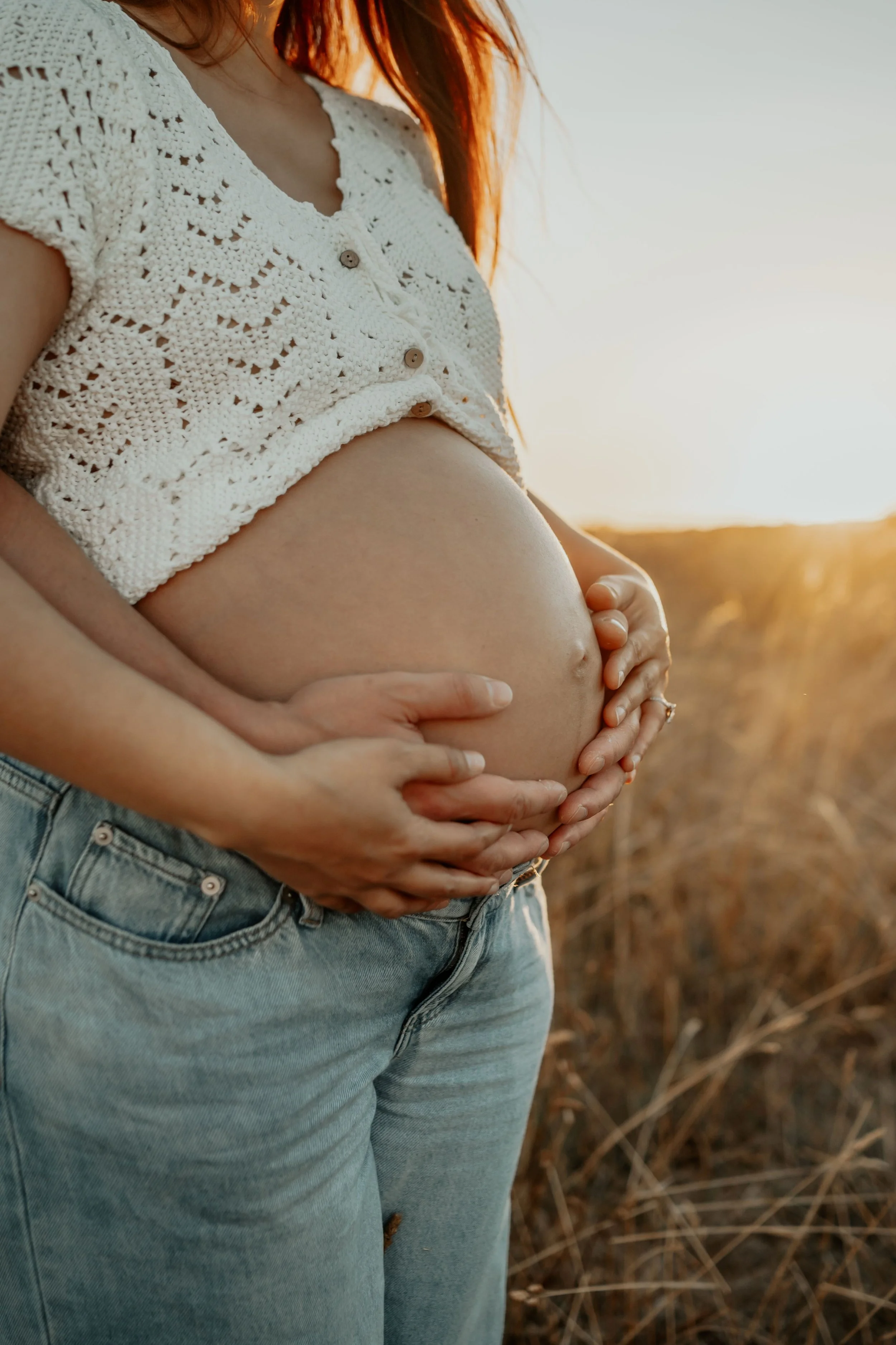 A pregnant belly with golden hour light shining on it