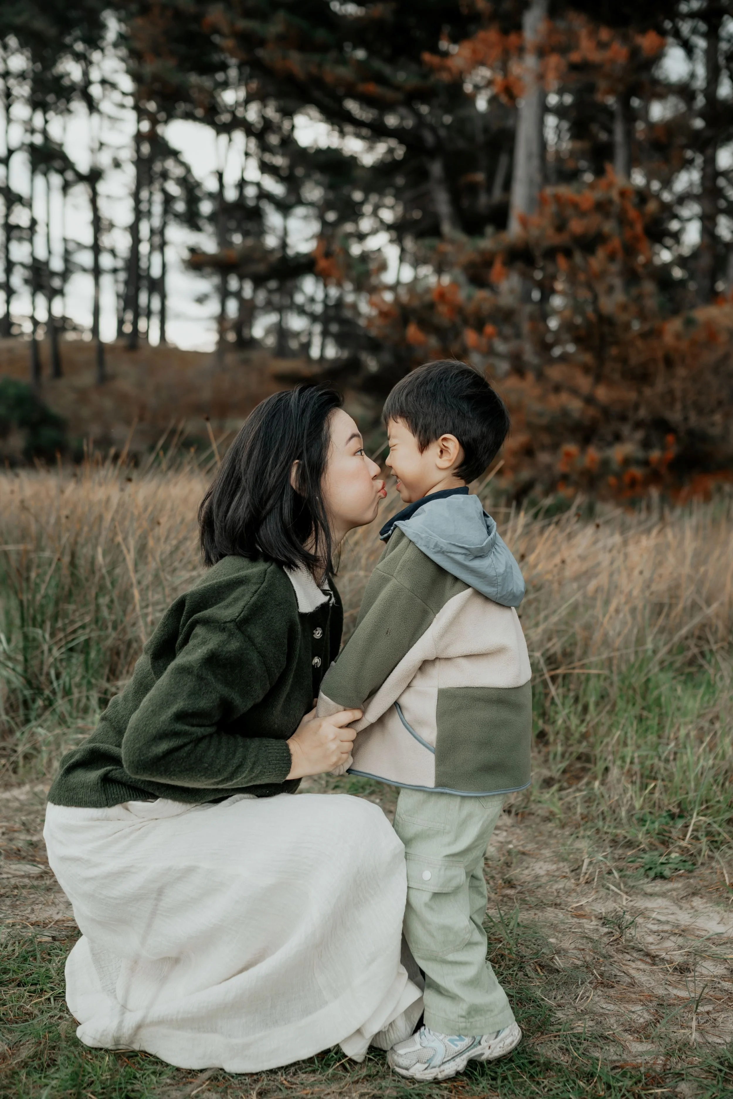 A mother pulling a face at her son making him laugh during a family photo session in Melbourne
