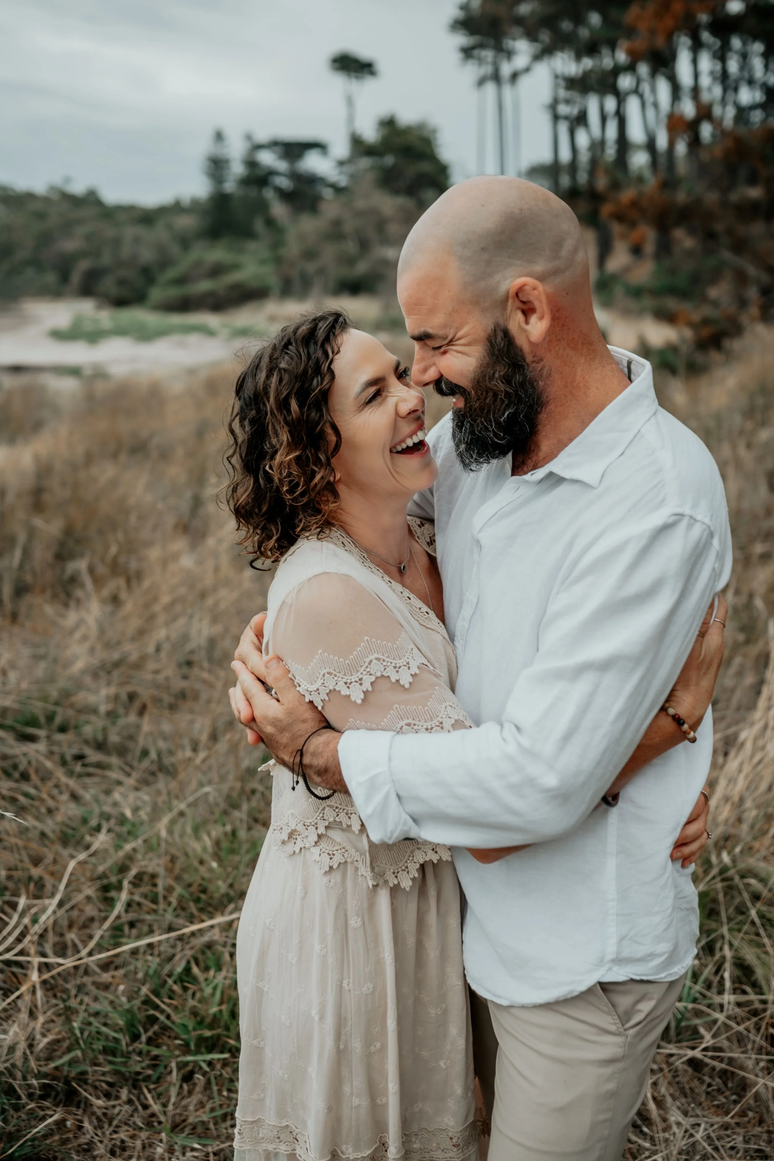 A couple share an intimate moment cuddling and touching noses and giggling