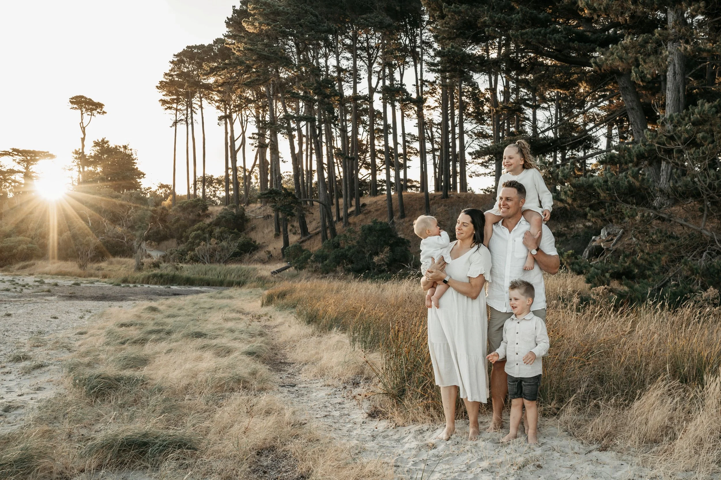 A family standing and watching the beach together