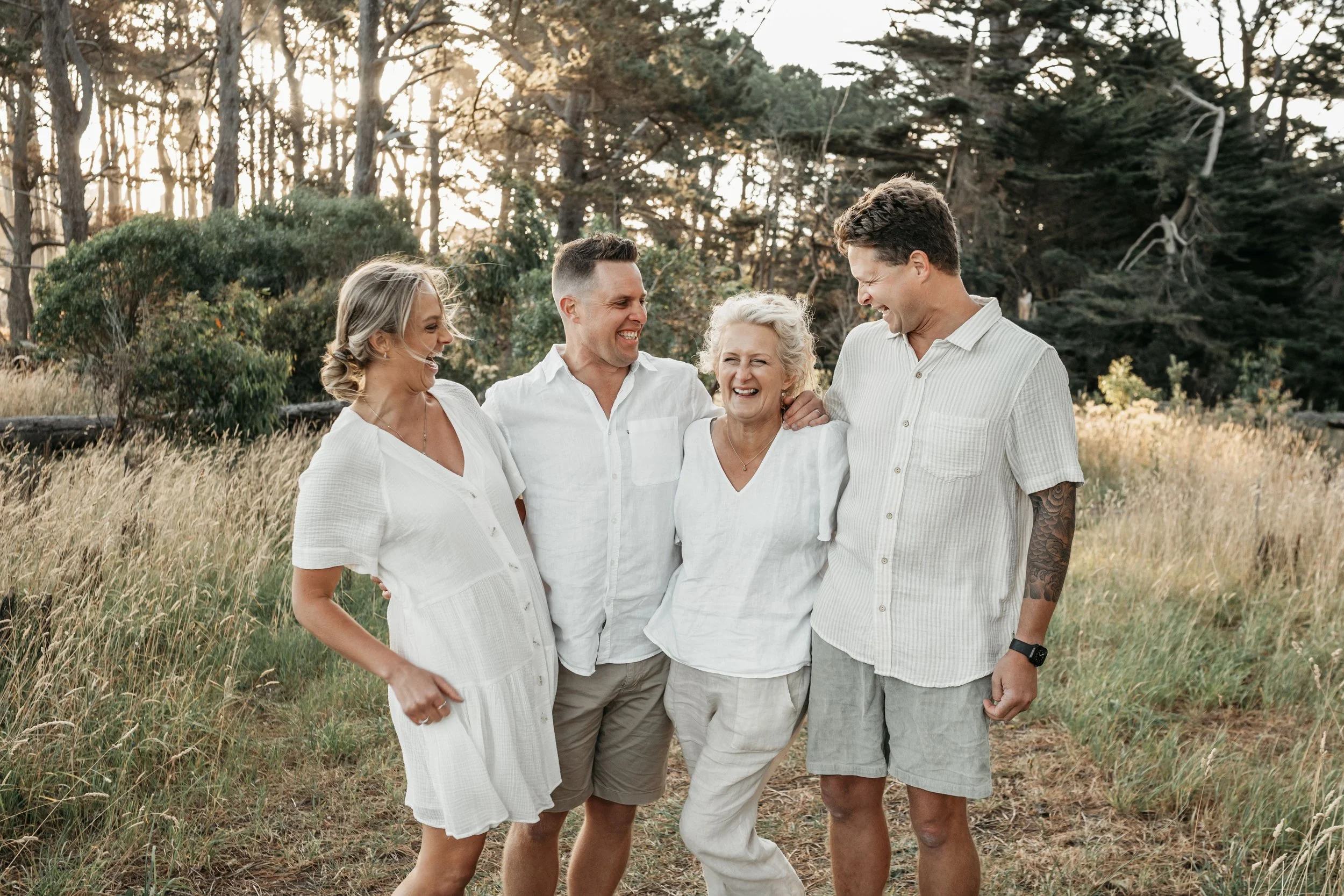 A mother with her adult children laughing together