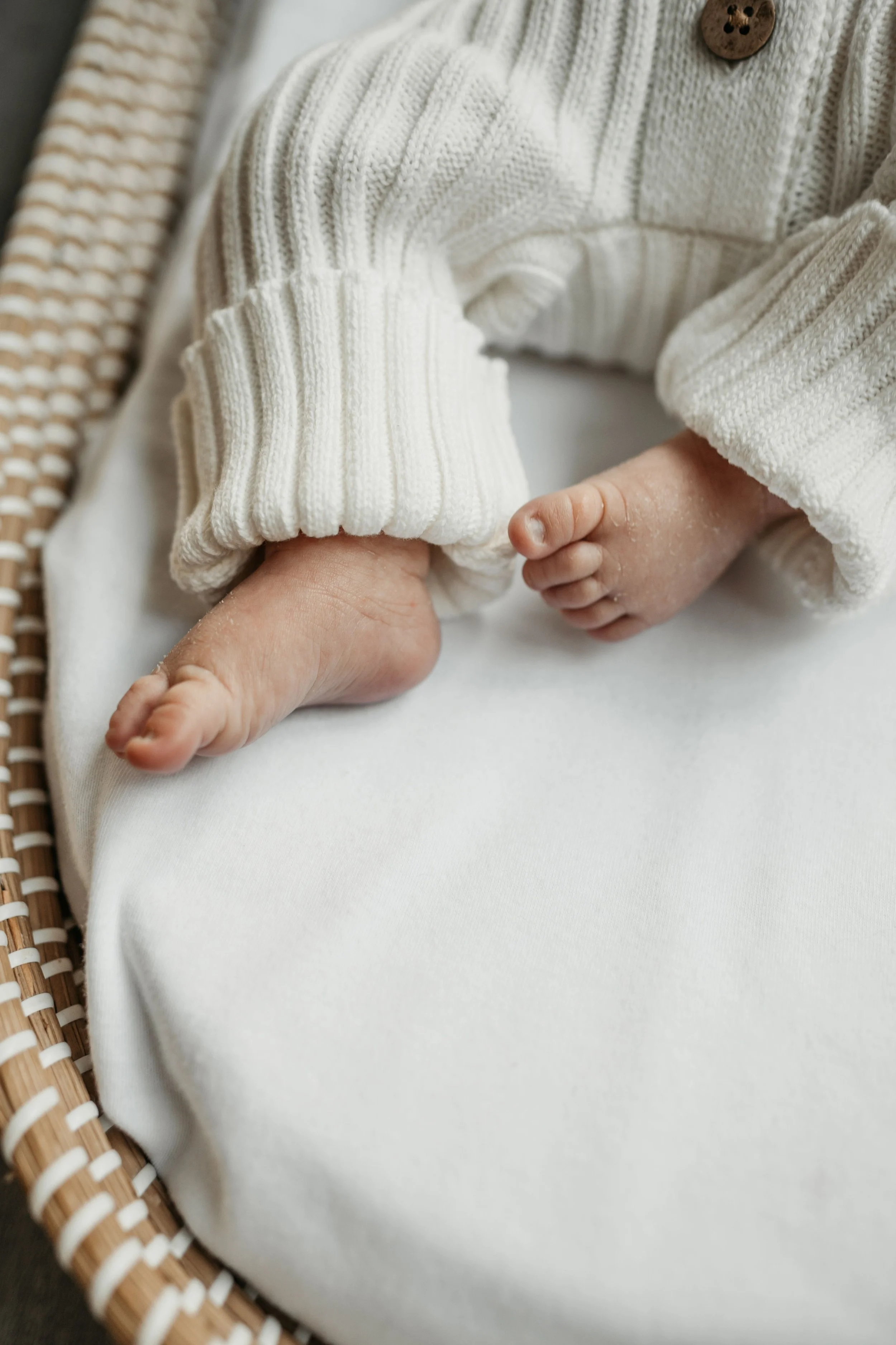 Newborn feet in a basket