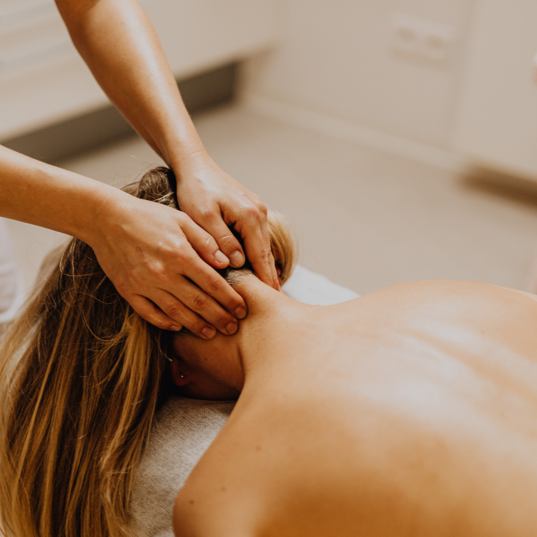 female getting massaged laying face down