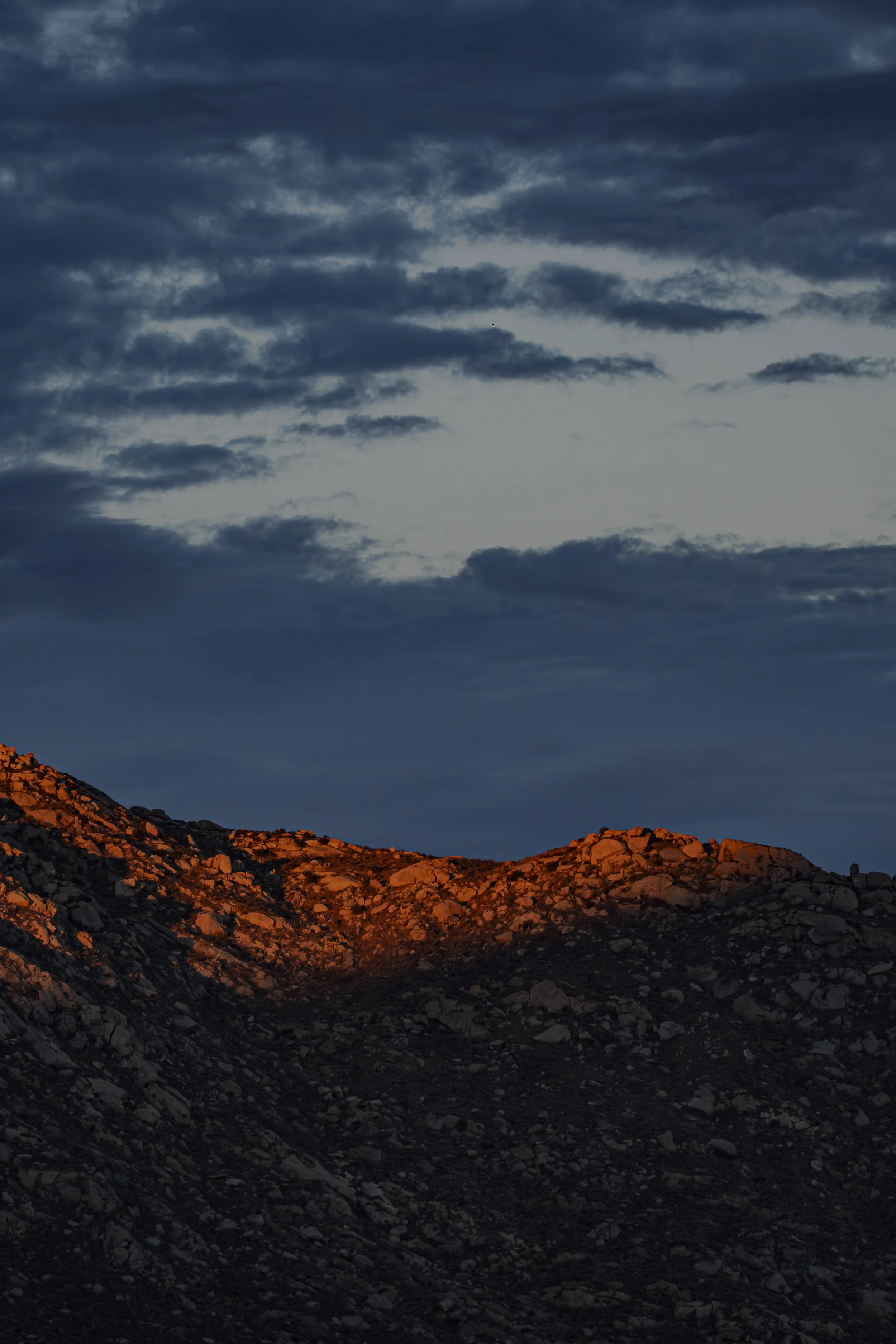 Which looks brighter: the mountain or the sky?