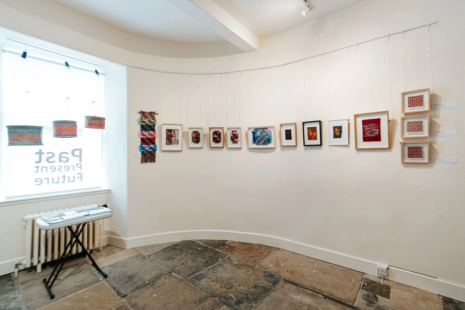 framed woven artwork on exhibition