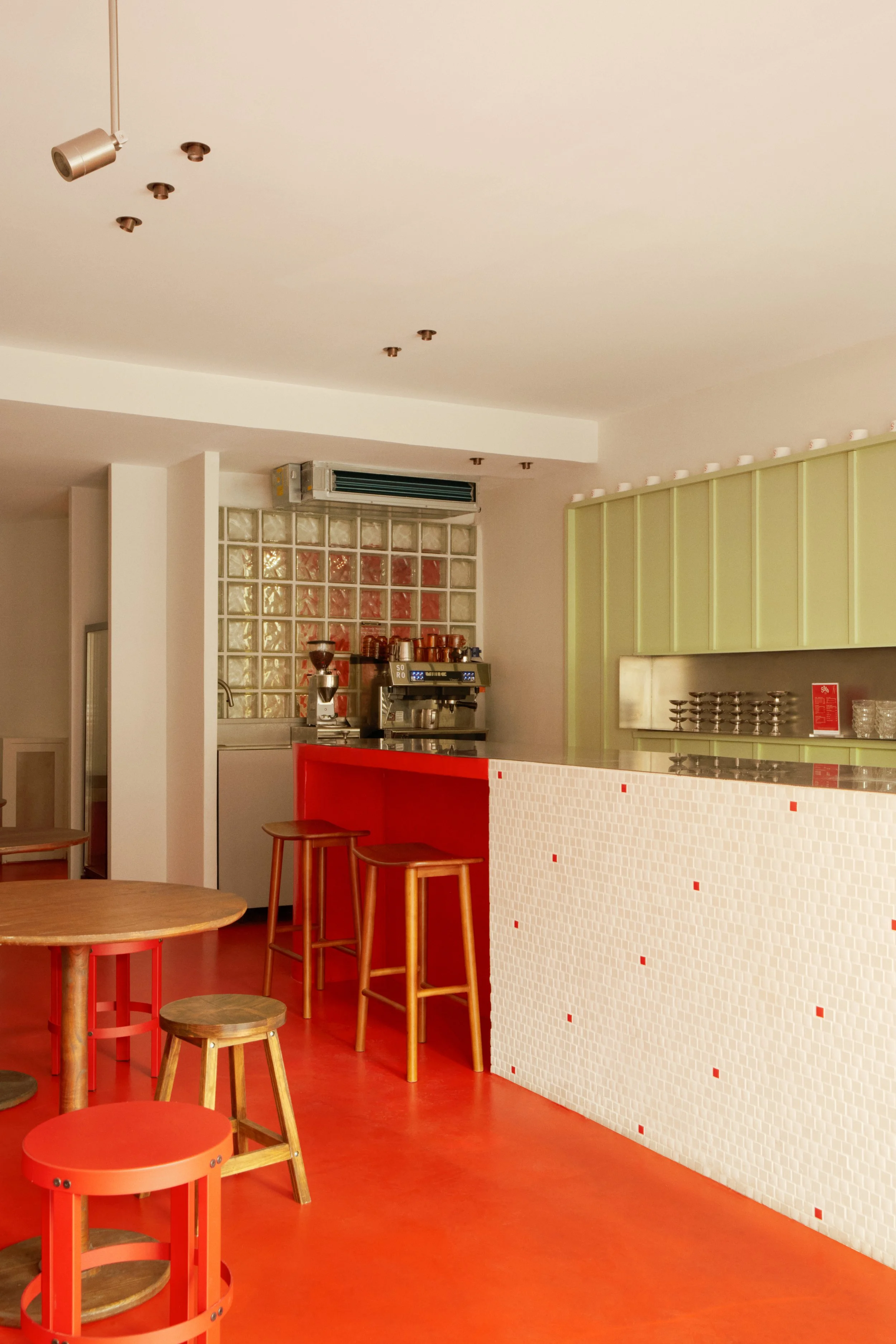 Aménagement intérieur du glacier SORO aux Catalans, avec comptoir arrondi, espace café, brique de verre et parcours client pensé pour un commerce alimentaire ERP.