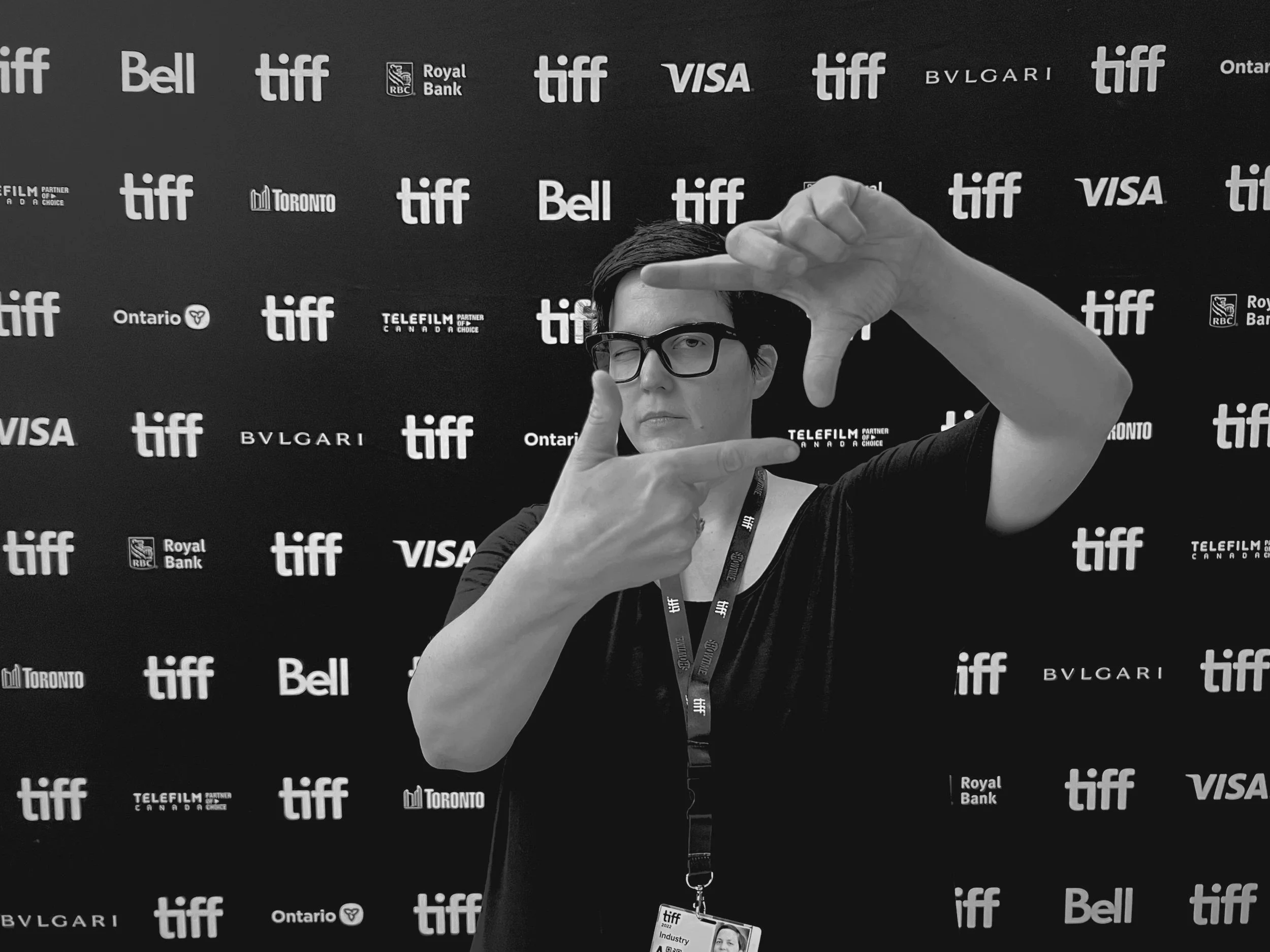 Person posing with hand Gestures in front of TIFF backdrop
