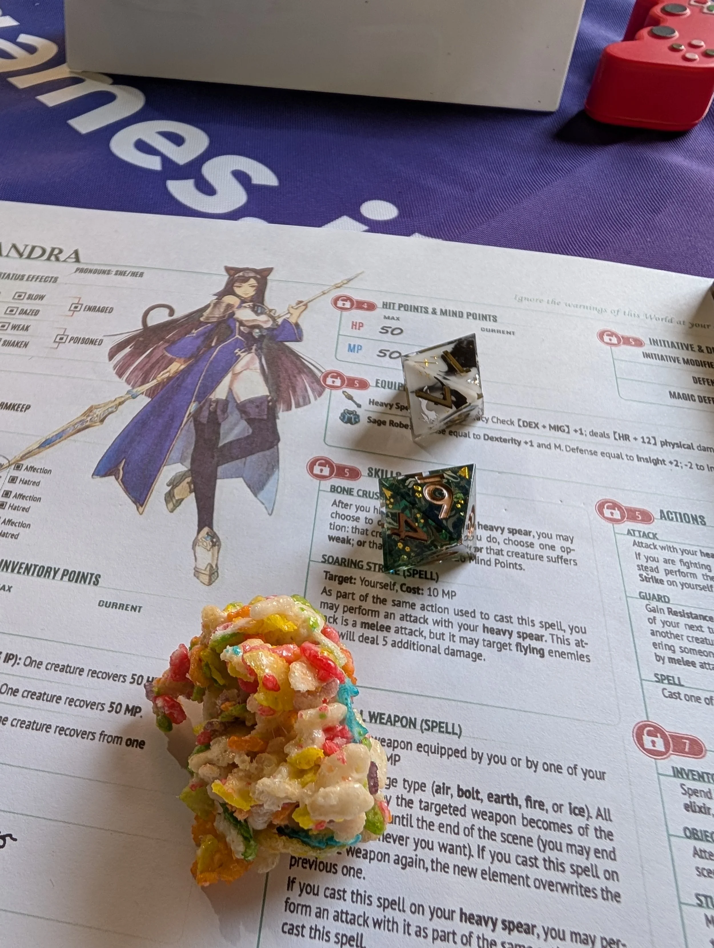 A colorful rice krispy treat, sitting on Susan's character sheet, surrounded by dice.