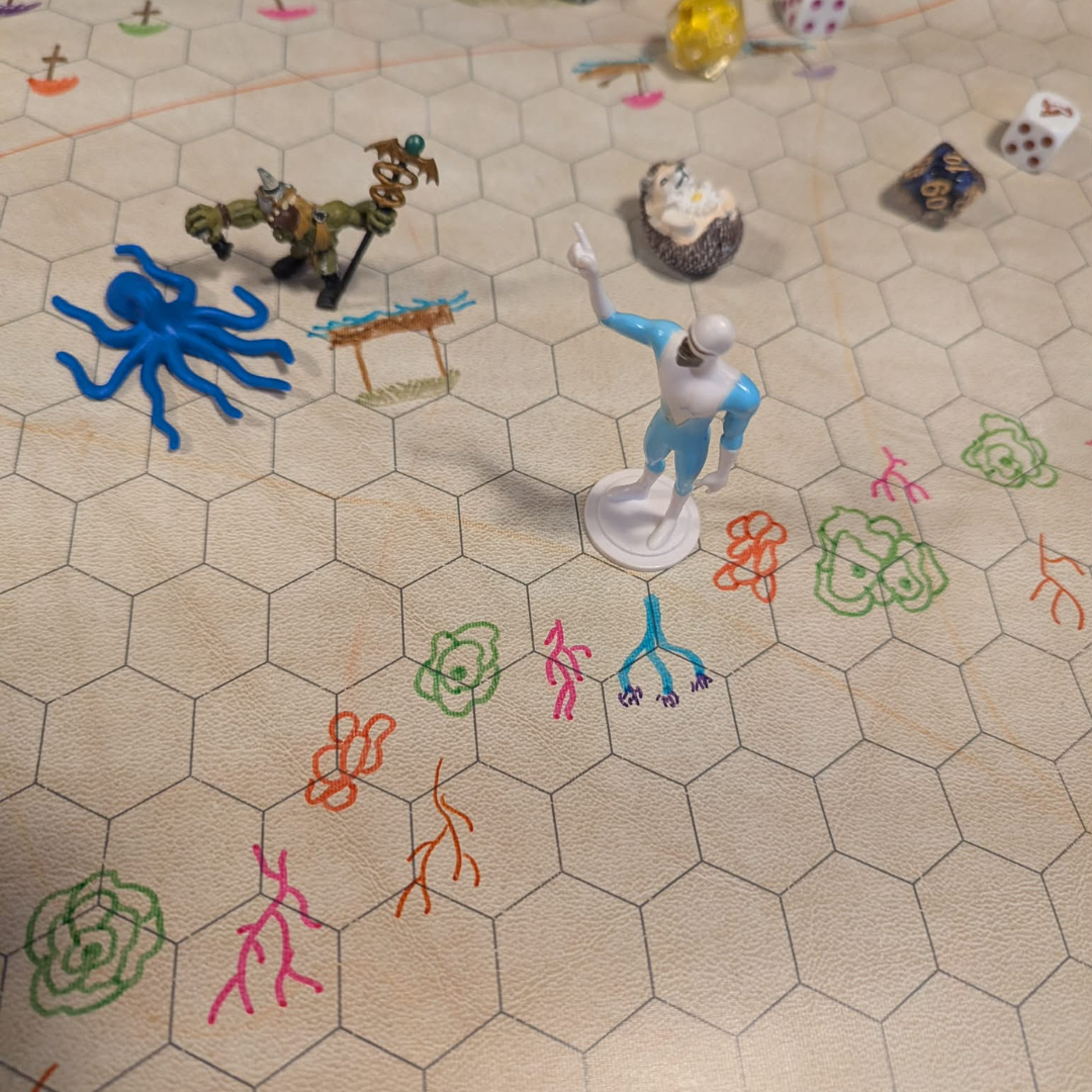 A wet-erase mat made for TTRPG combat, with a crude drawing of a coral reef.
