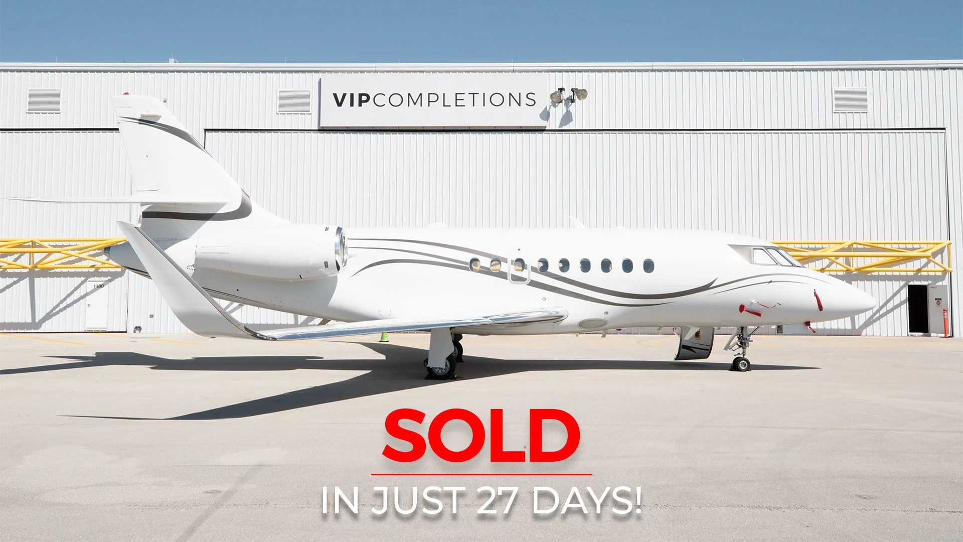 White private jet parked on tarmac in front of a hangar with the sign 'VIP COMPLETIONS'. Red text overlay says 'SOLD IN JUST 27 DAYS!'