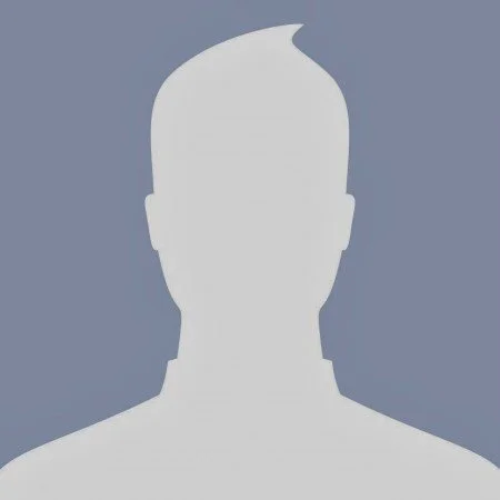 Silhouette of a person’s head and shoulders against a blue background.