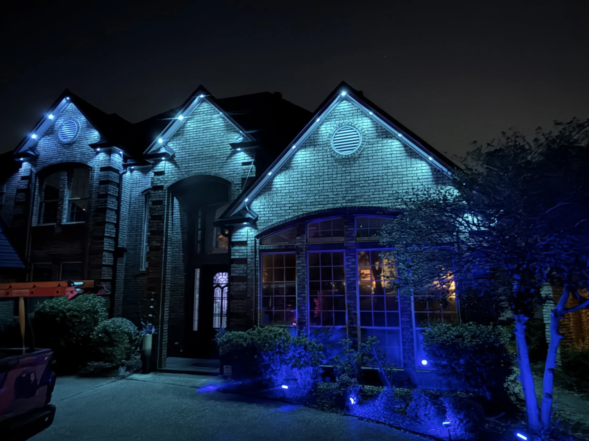 Dallas Fort Worth home with blue permanent exterior Govee lighting installed along roofline.