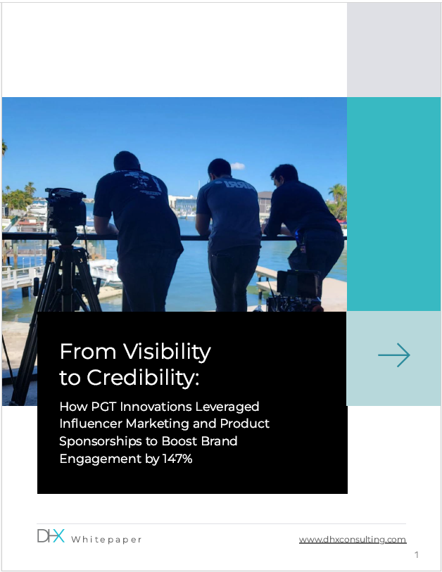 Three people, likely videographers, standing on a dock by the water, filming with cameras. They are facing away from the camera towards the water and boats.