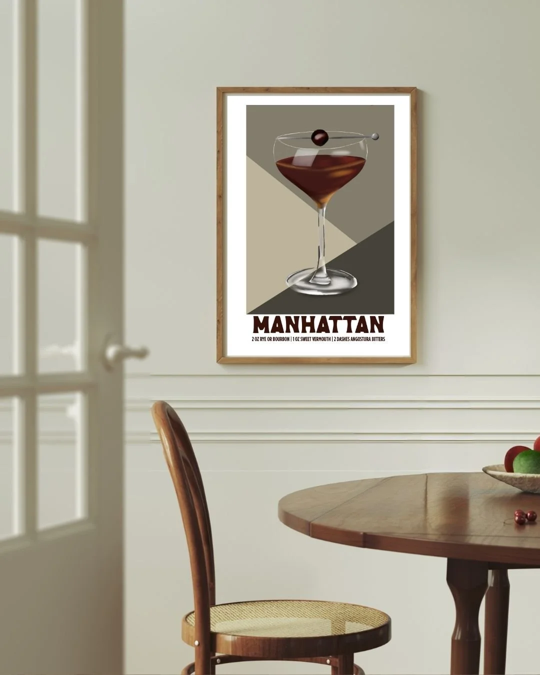 Manhattan cocktail art print framed above a dining room table