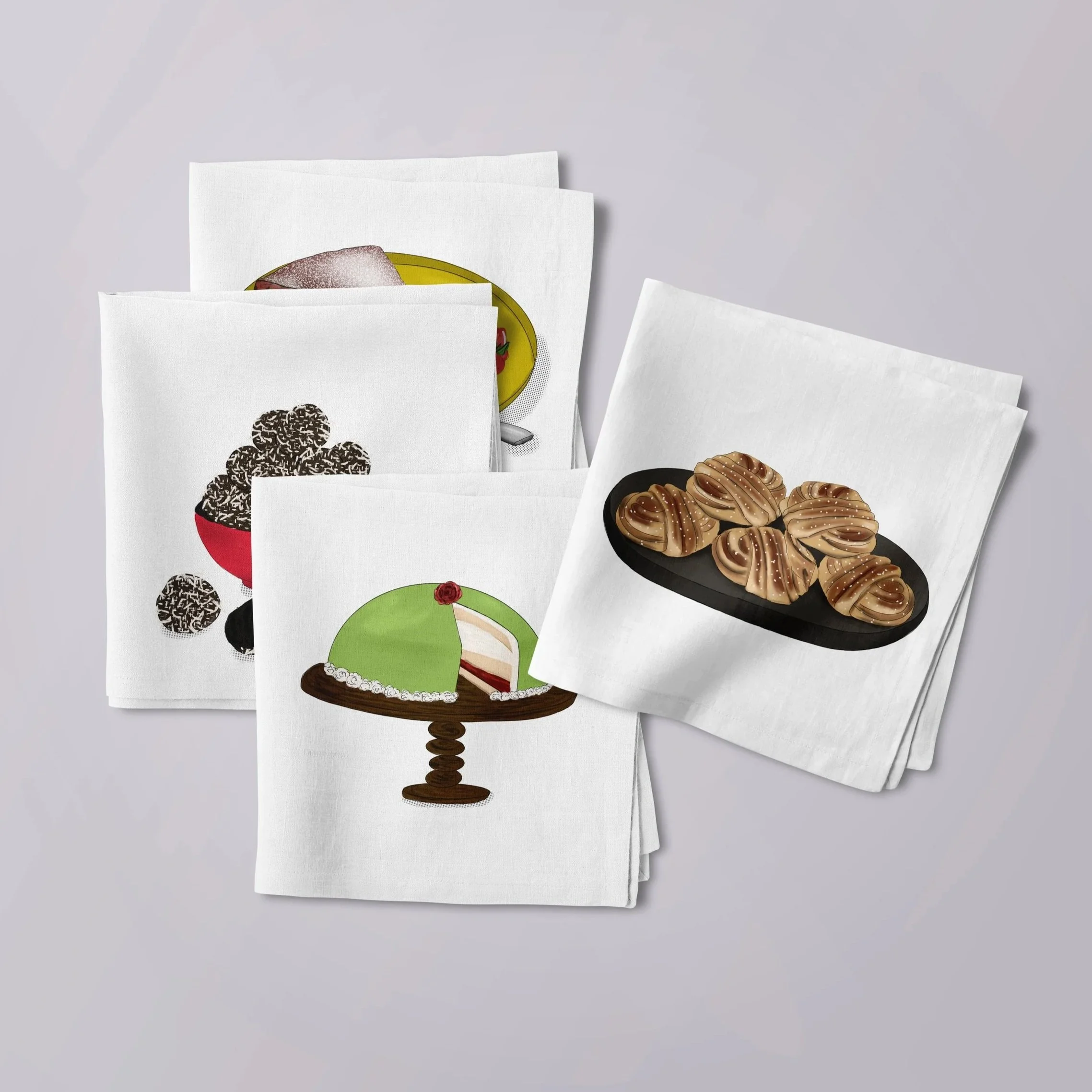 A flat lay mockup of four white cocktail napkins, each printed with a different Swedish fika illustration: chokladbollar in a red bowl, a princess torte on a cake stand, kanelbullar on a dark plate, and a slice of kladdkaka.