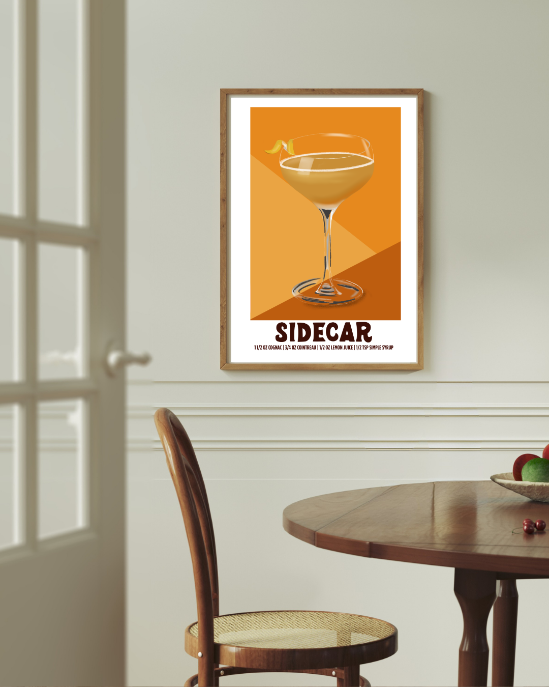Sidecar cocktail art print styled above a dining room table