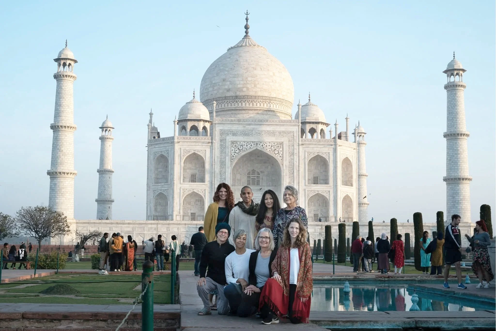 Wellness travel group at the Taj Mahal in India, symbolizing sacred exploration, community connection, and transformative Ayurvedic journeys