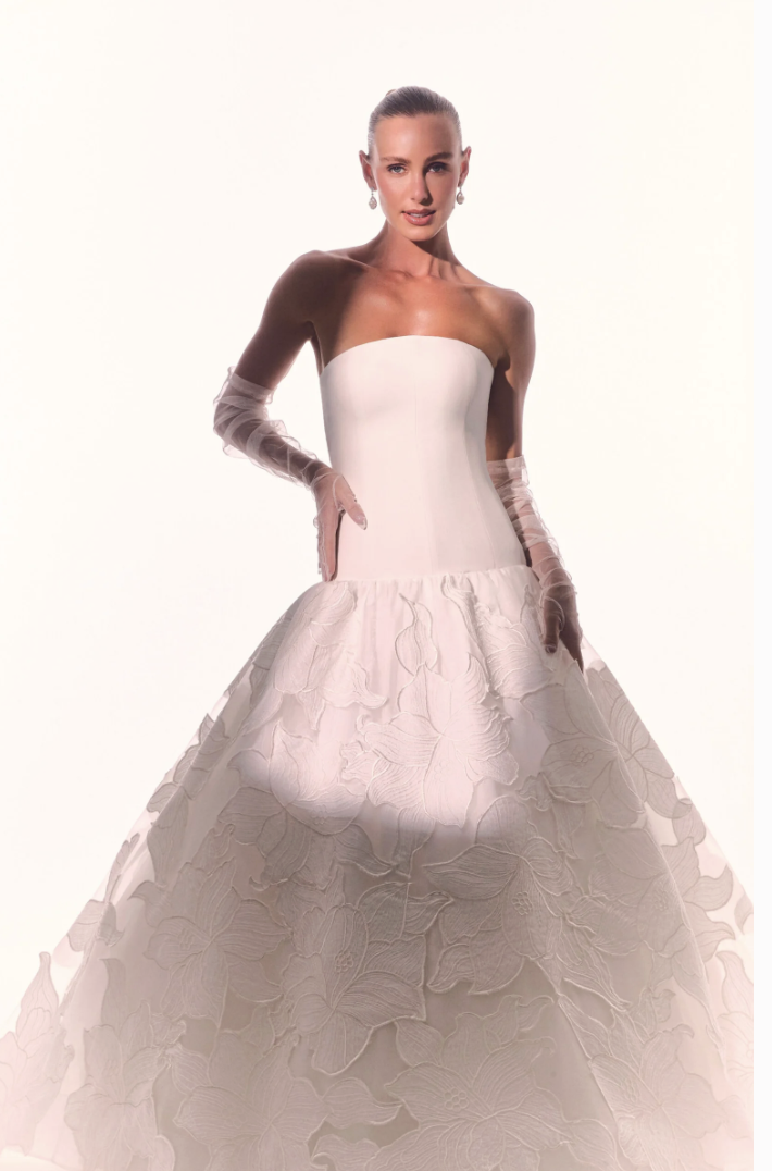 Unique bridal gown by Brazilian designer Stephanie Cachapuz, featuring a textured floral skirt, drop-waist, and structured bodice