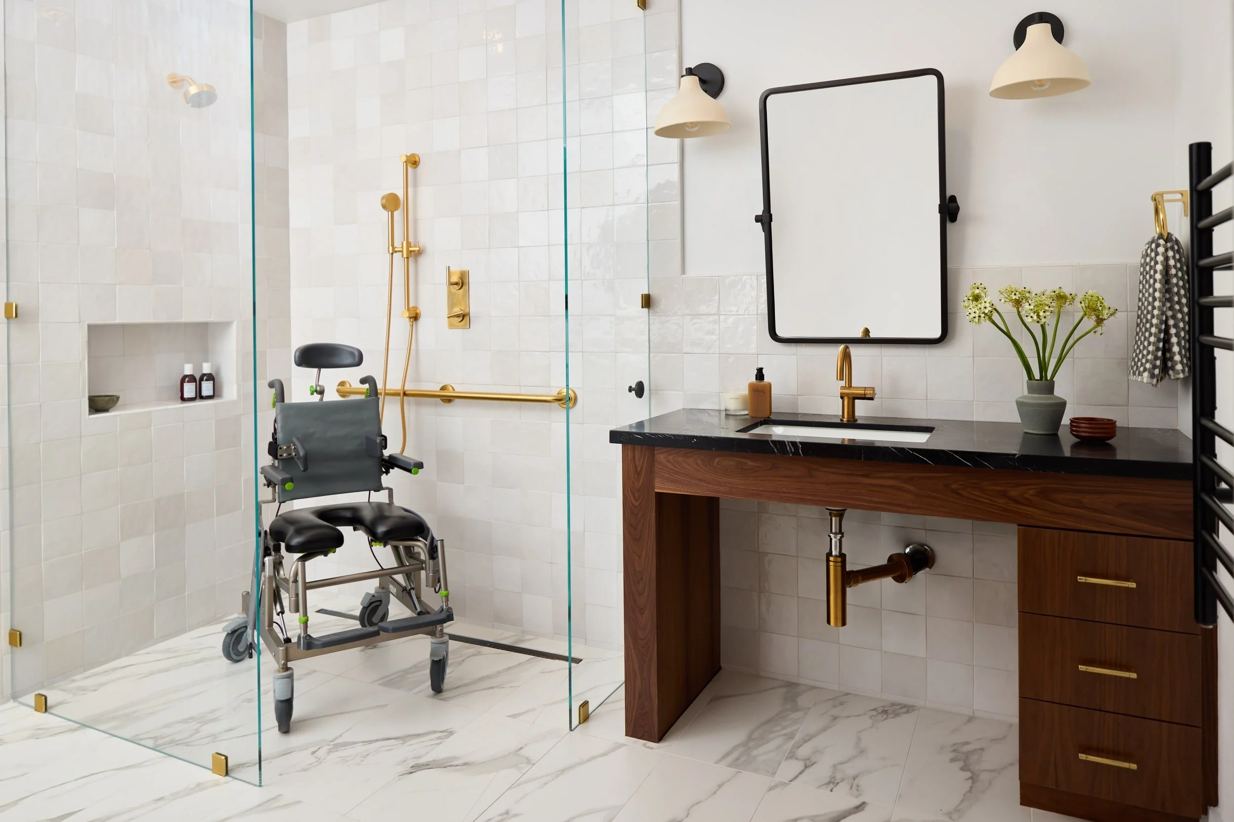 Accessible bathroom with a curbless roll-in shower, grab bars, shower chair and walnut vanity