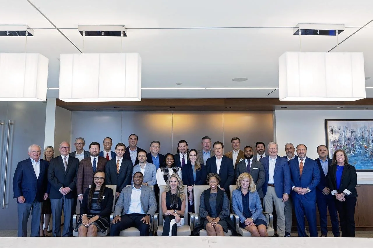 Samford University Cumberland School of Law's Alumni Advisory Board Members posing for a photo at their annual meeting in October 2024. Group of well-dressed professionals posing in a conference room.