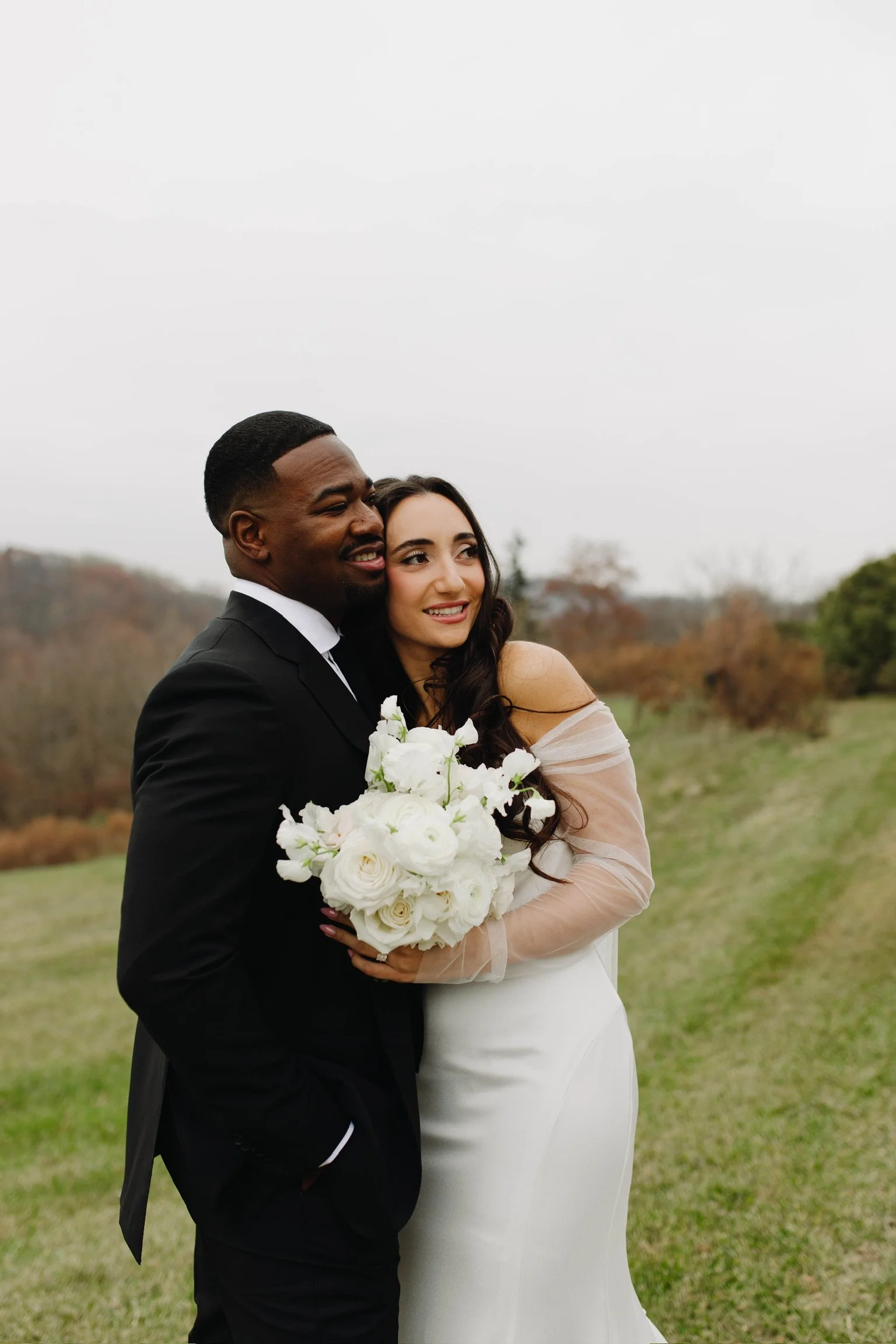 Hudson Valley wedding couple at The Garrison with a romantic white bouquet
