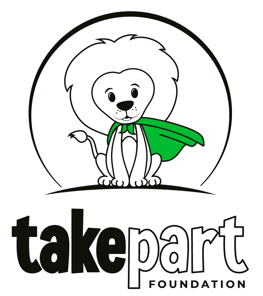 A cartoon lion wearing a green cape and a collar, with the text 'takepart FOUNDATION' below.