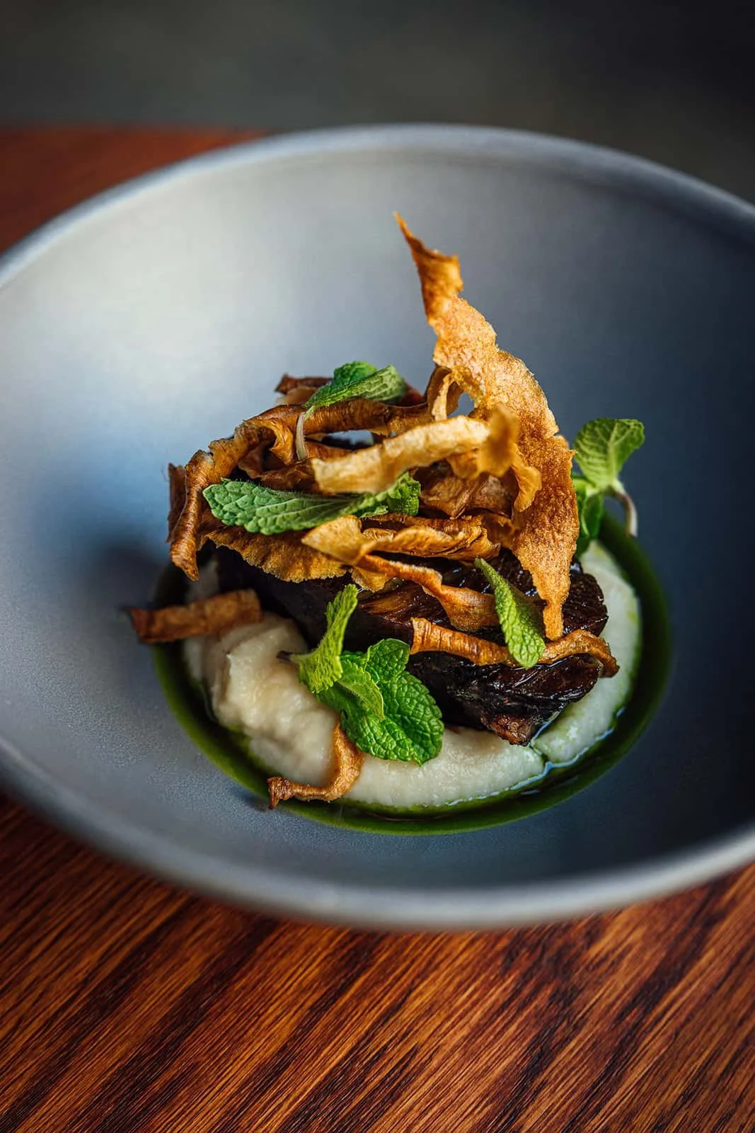 Seasonal fine dining dish with vegetables and herbs at restaurant Helsinki