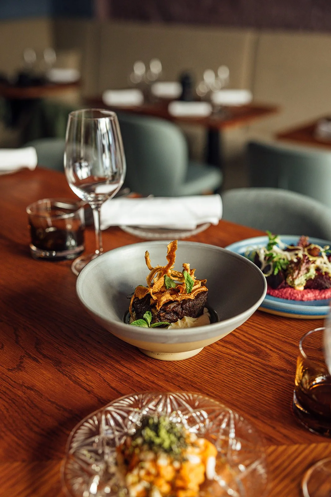 Shared dishes and wine glassess at Flor Helsinki