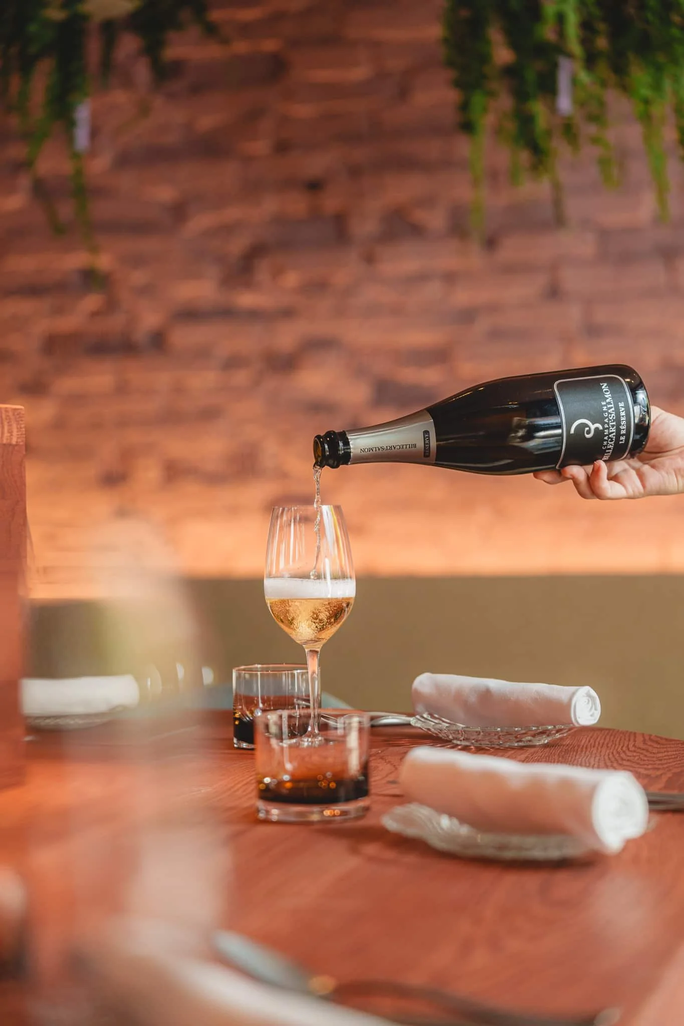 Pouring sparkling wine into glass at wine bar Helsinki