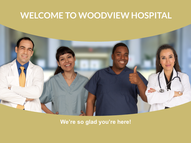 A group of four healthcare professionals, including doctors and nurses, standing together in a hospital lobby with a welcoming message that reads, "Welcome to Woodview Hospital. We're so glad you're here!"