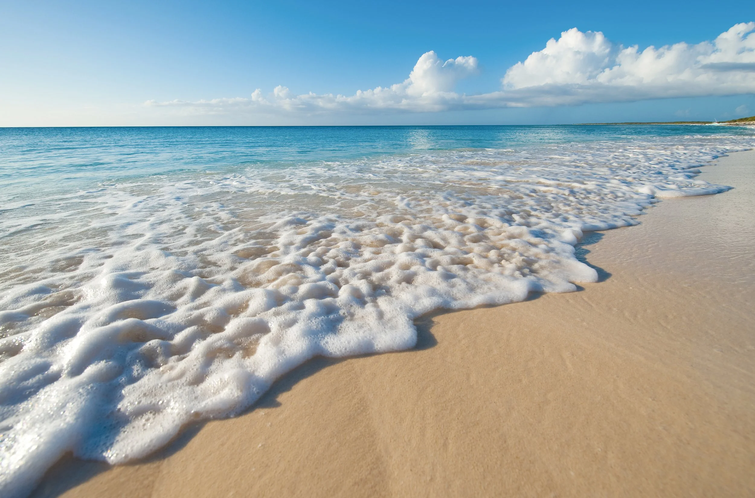 Beach with waves and blue sky